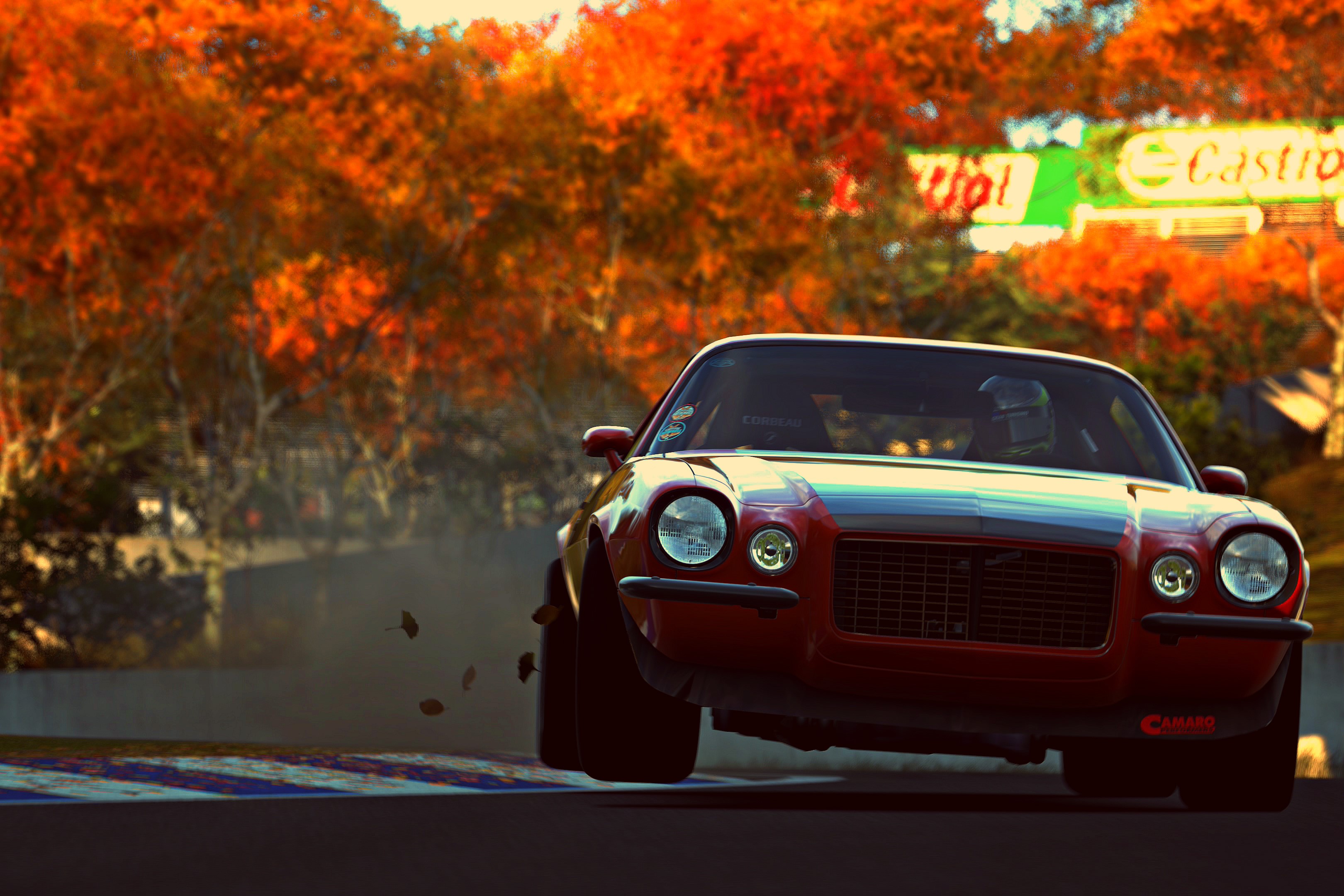 Red Chevrolet Camaro RS on a race track with autumn trees HD Wallpaper