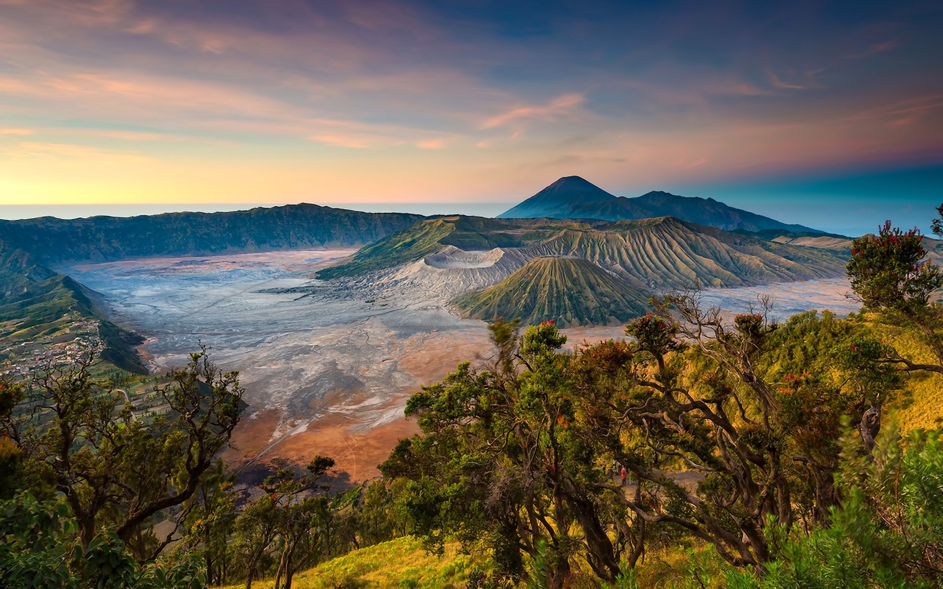 Volcanic landscape with mountains and trees at sunrise HD Wallpaper