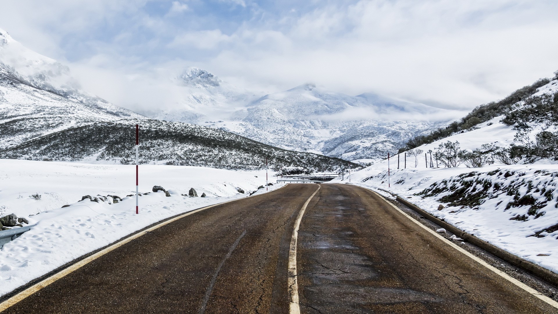 A snowy mountain road in winter HD Wallpaper