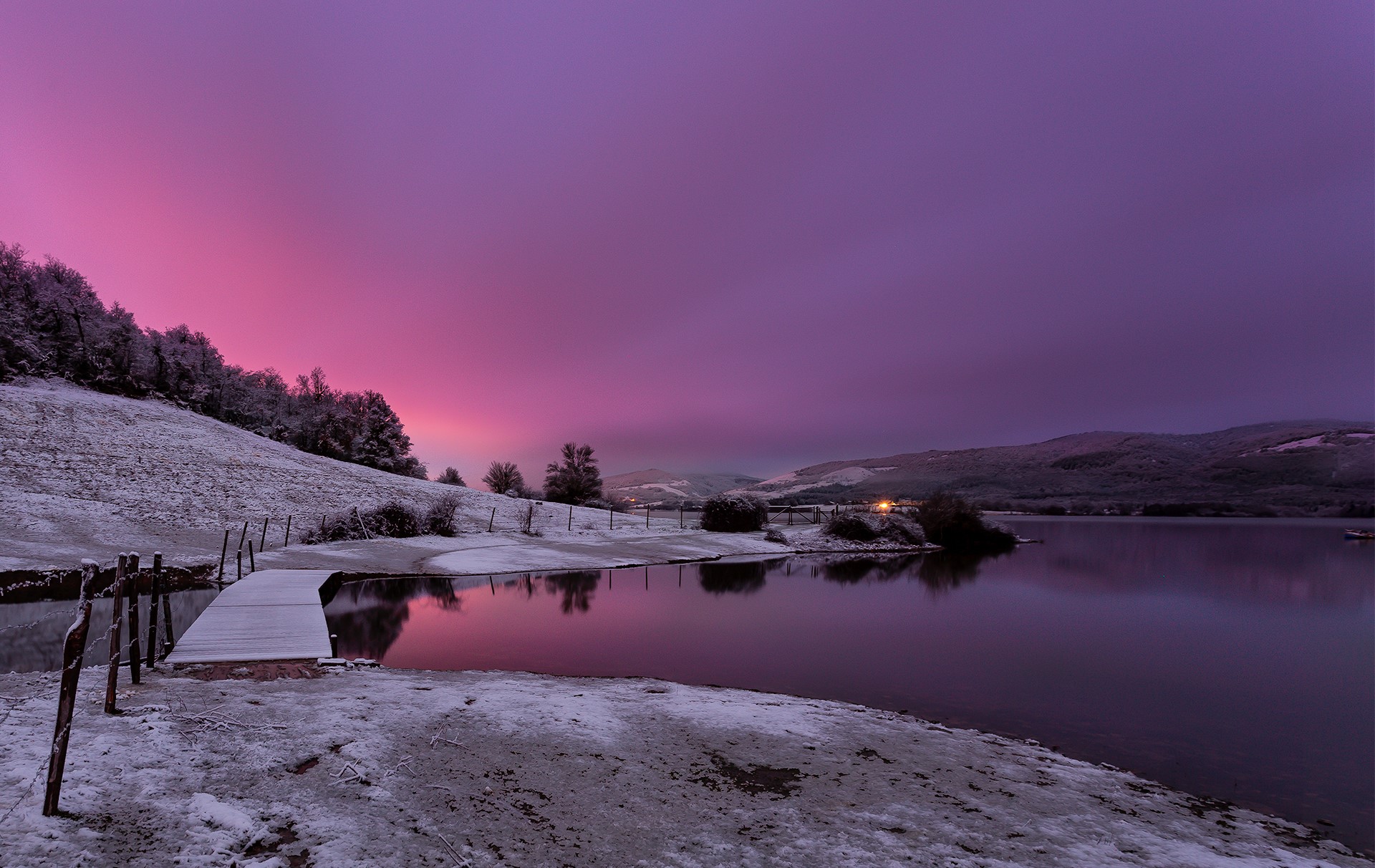Snowy landscape with a wooden pier and a lake at sunset HD Wallpaper