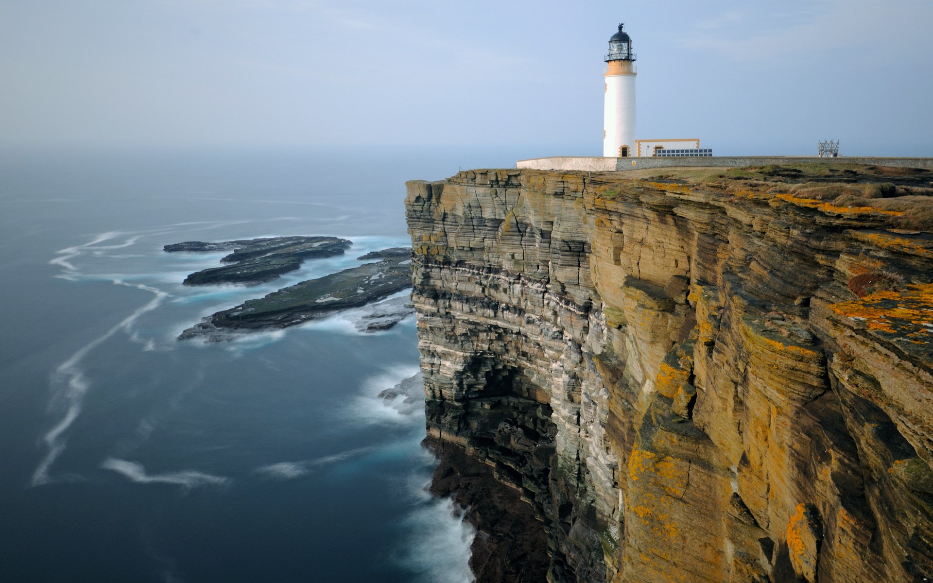 Lighthouse on a cliff overlooking the sea HD Wallpaper