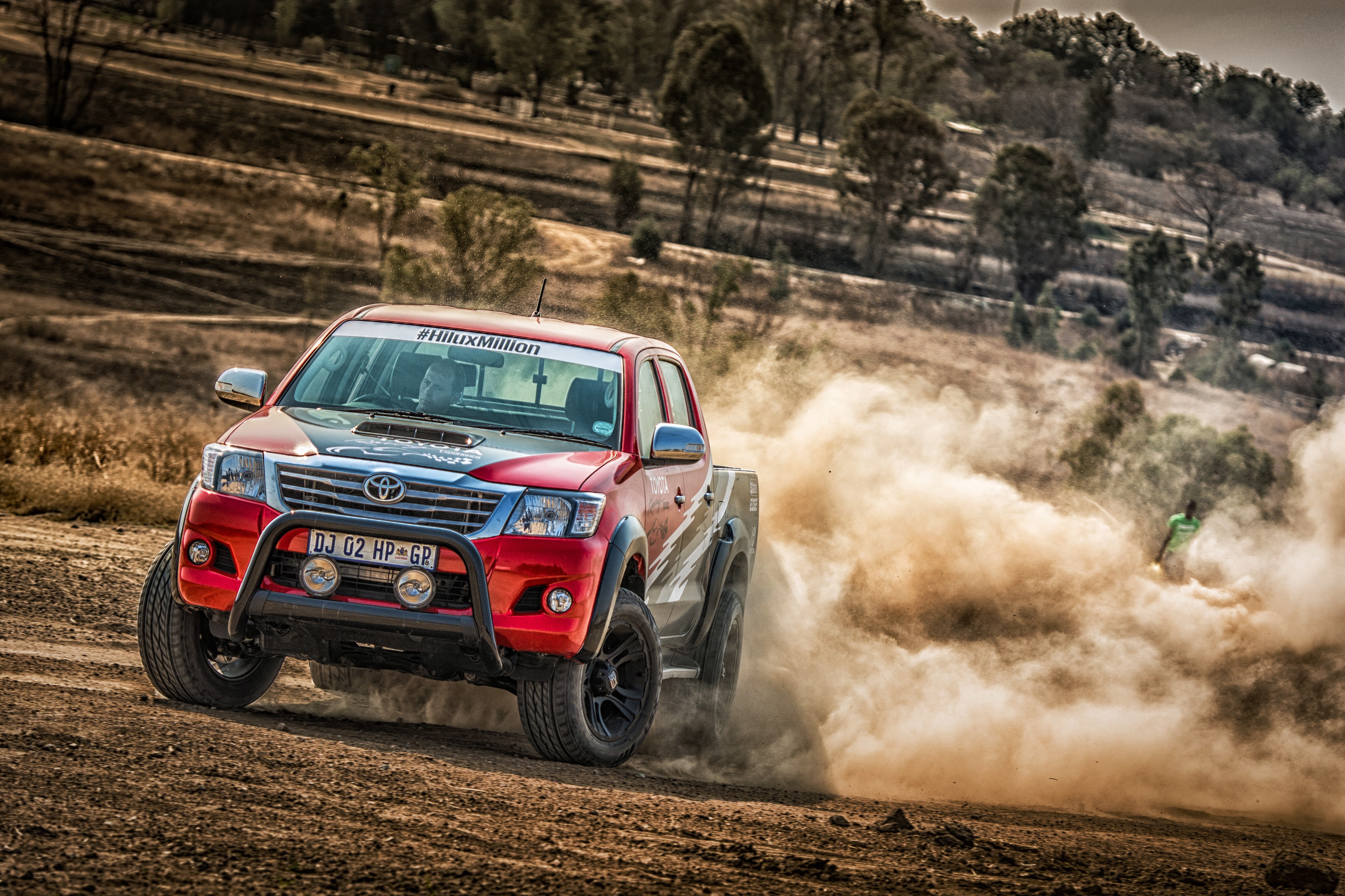 Red Toyota Hilux racing off-road HD Wallpaper