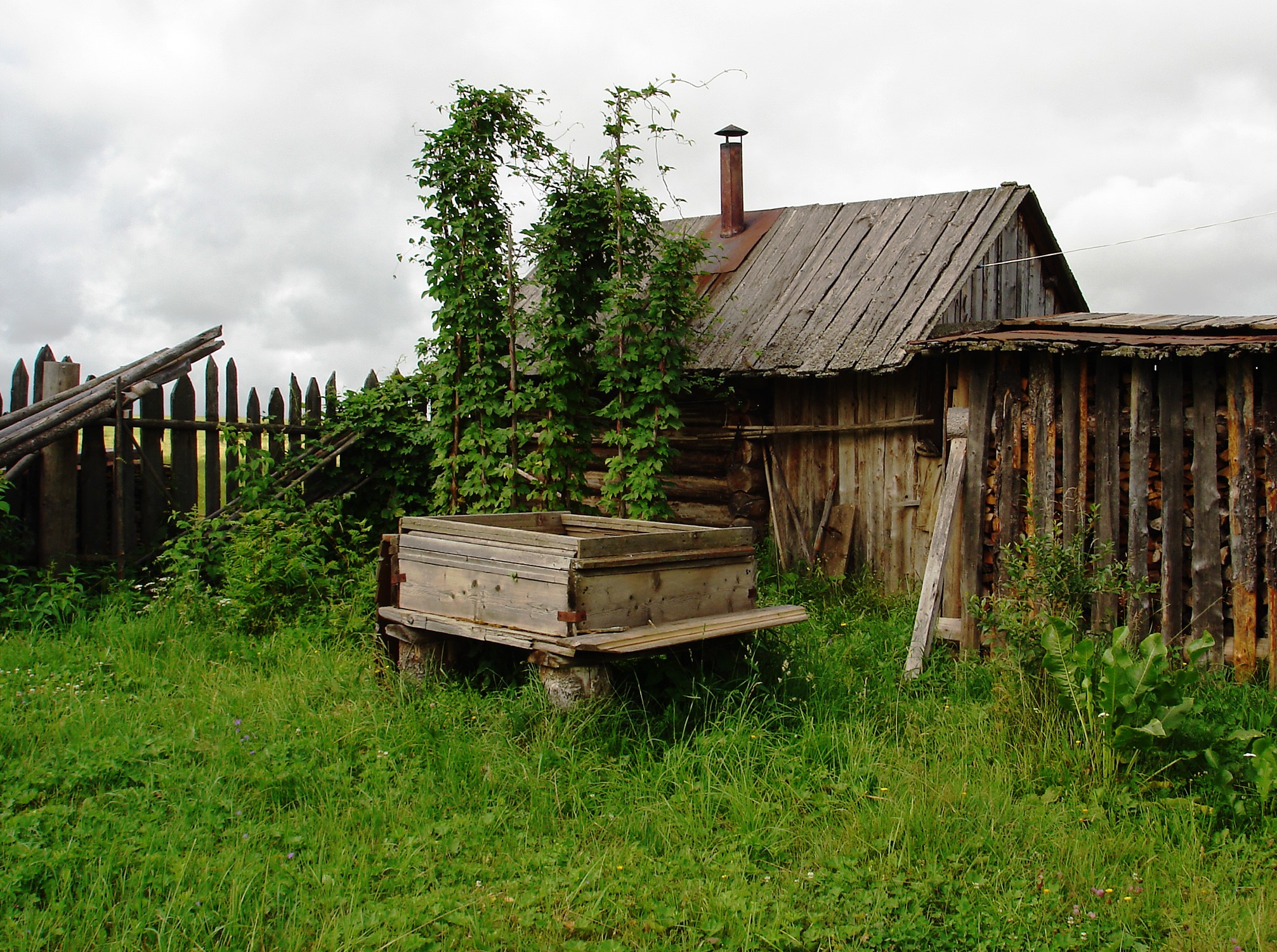 Old wooden house with a cart and fence HD Wallpaper