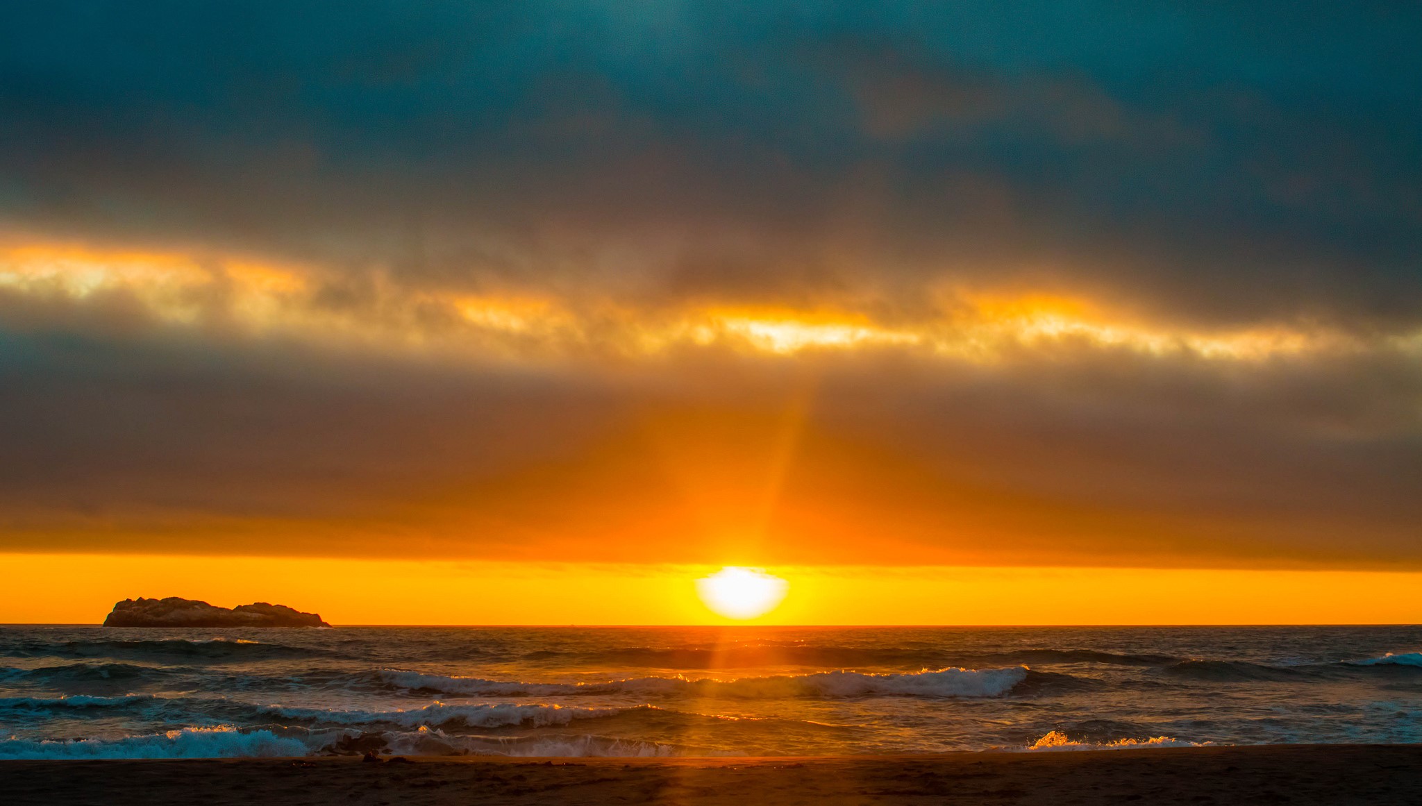 Sunset over the ocean with a small island HD Wallpaper