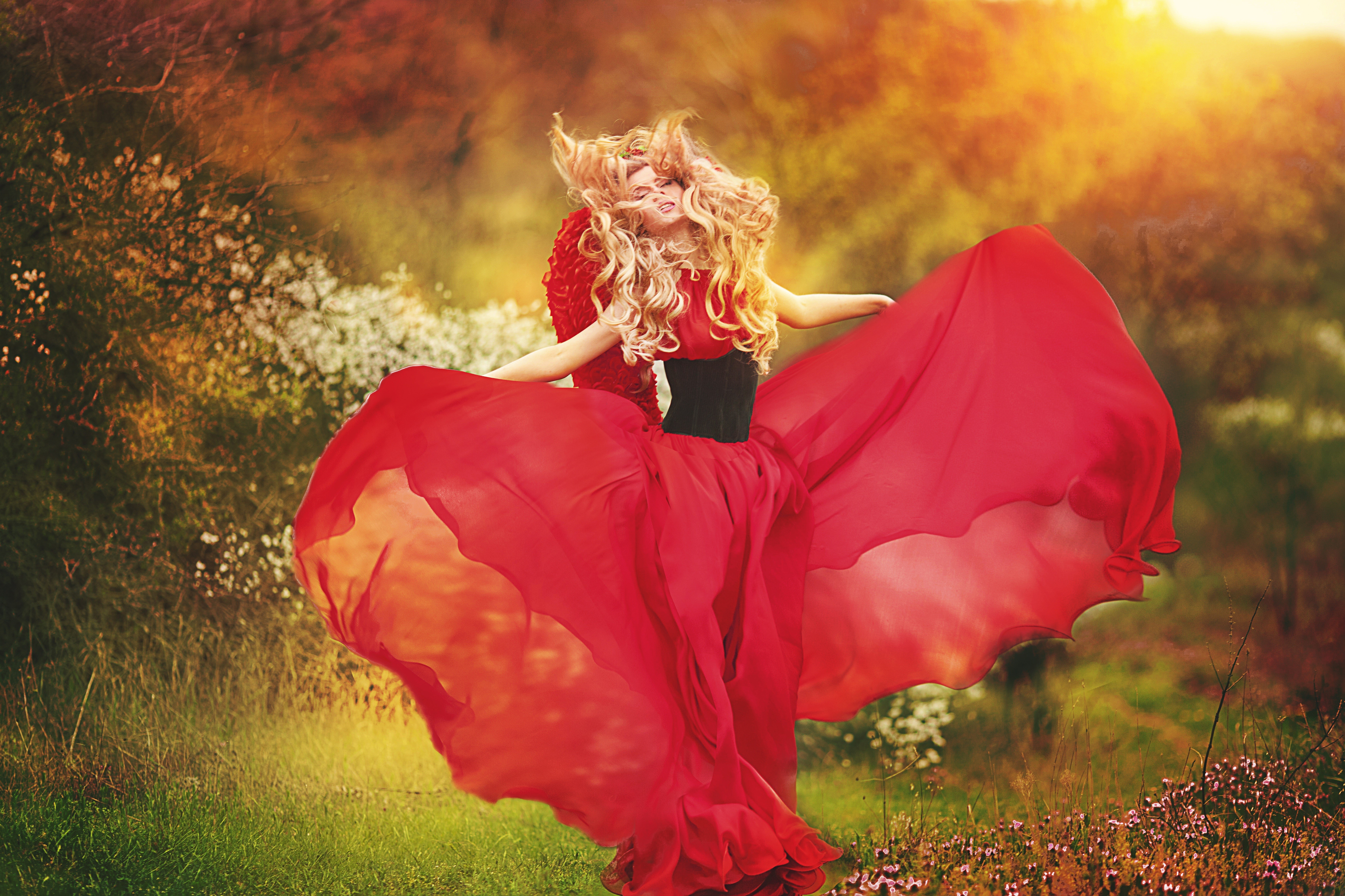 Blonde girl in a red dress dancing in a field HD Wallpaper