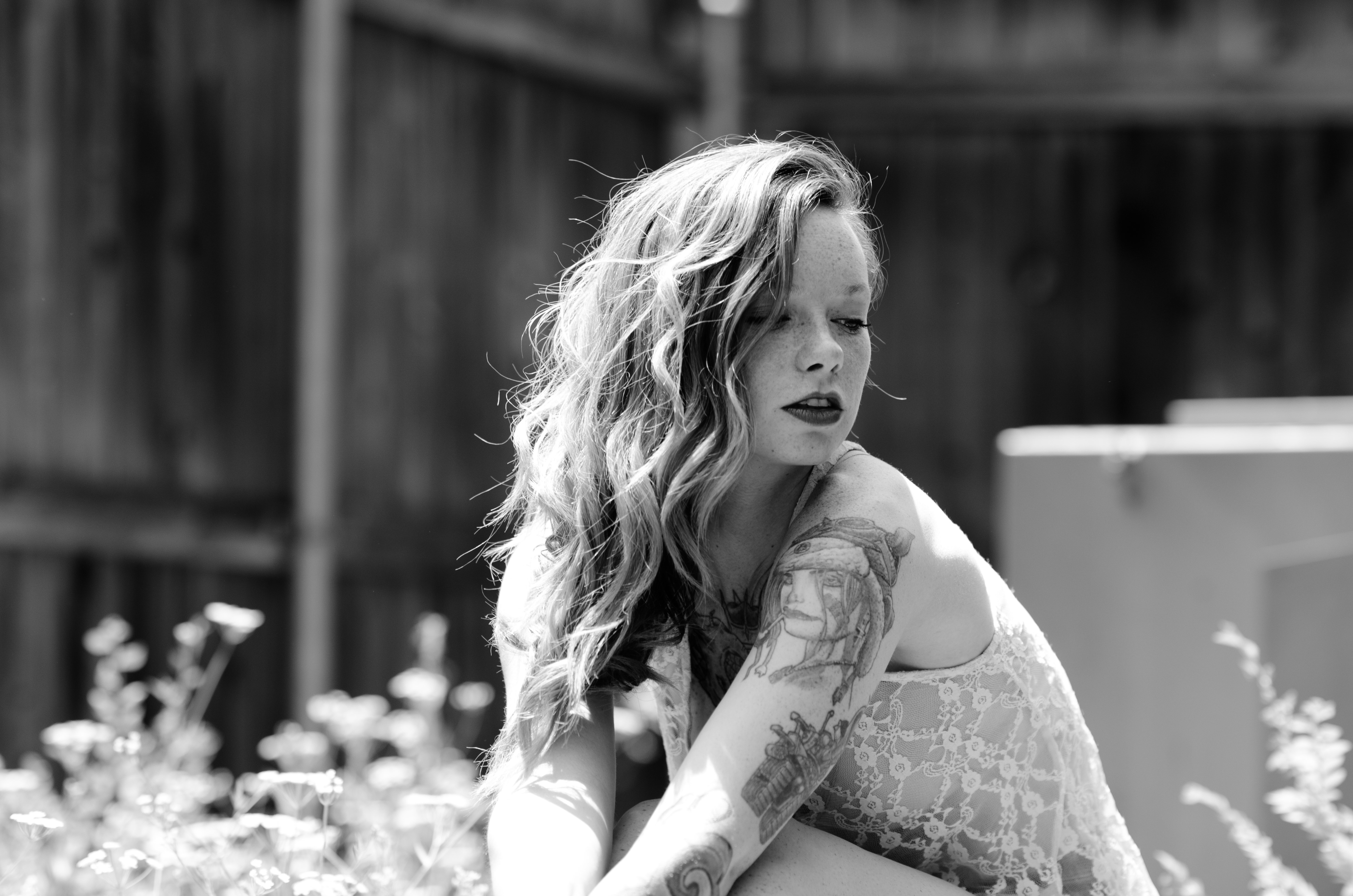 Woman with tattoos and curly hair HD Wallpaper