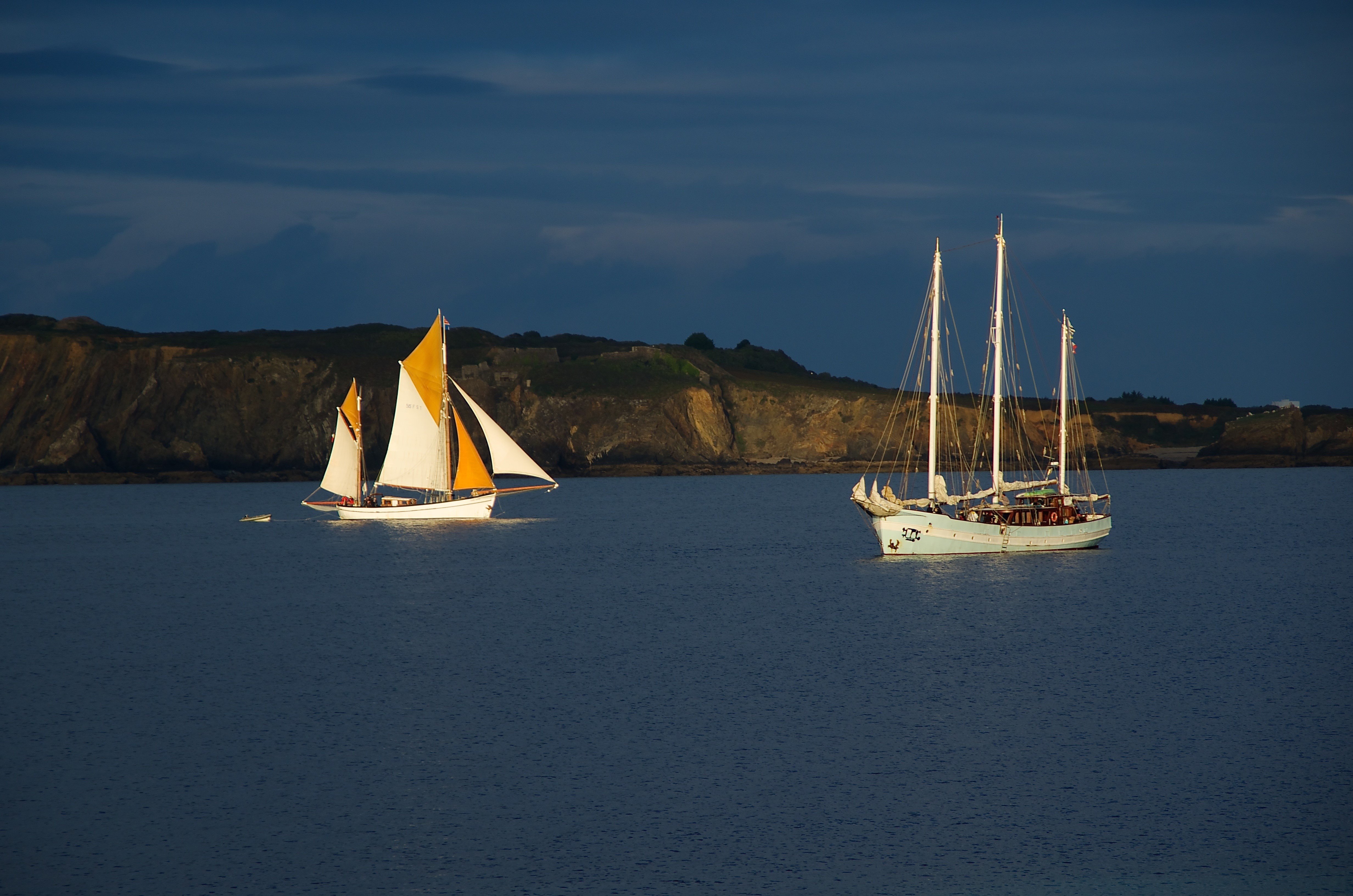 Two sailboats on the sea near a cliff HD Wallpaper