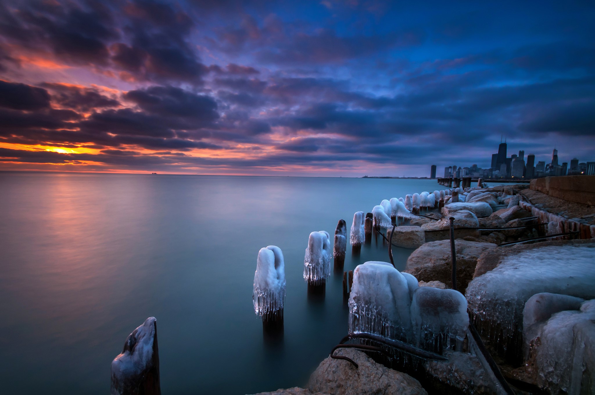Chicago skyline at sunrise with icy lakefront HD Wallpaper