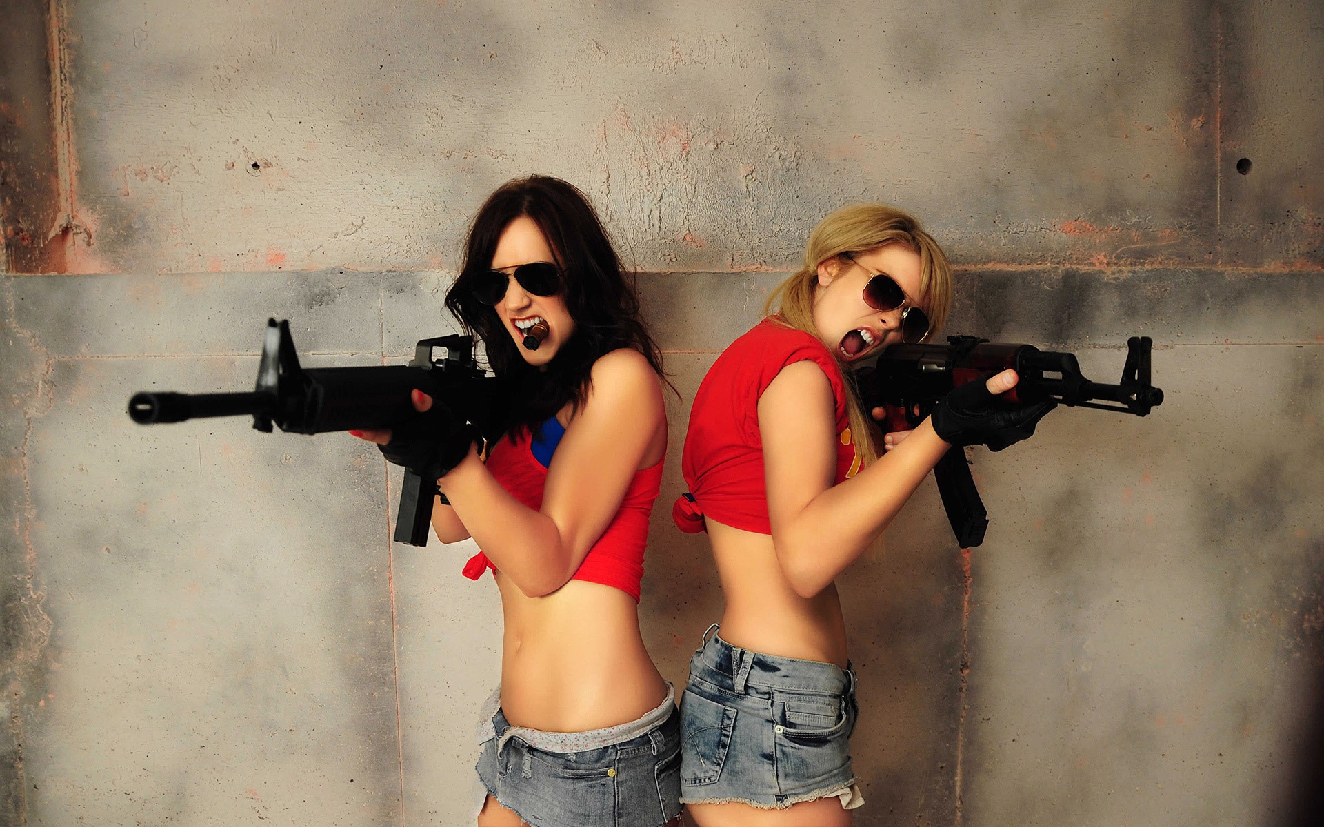 Two women with assault rifles HD Wallpaper