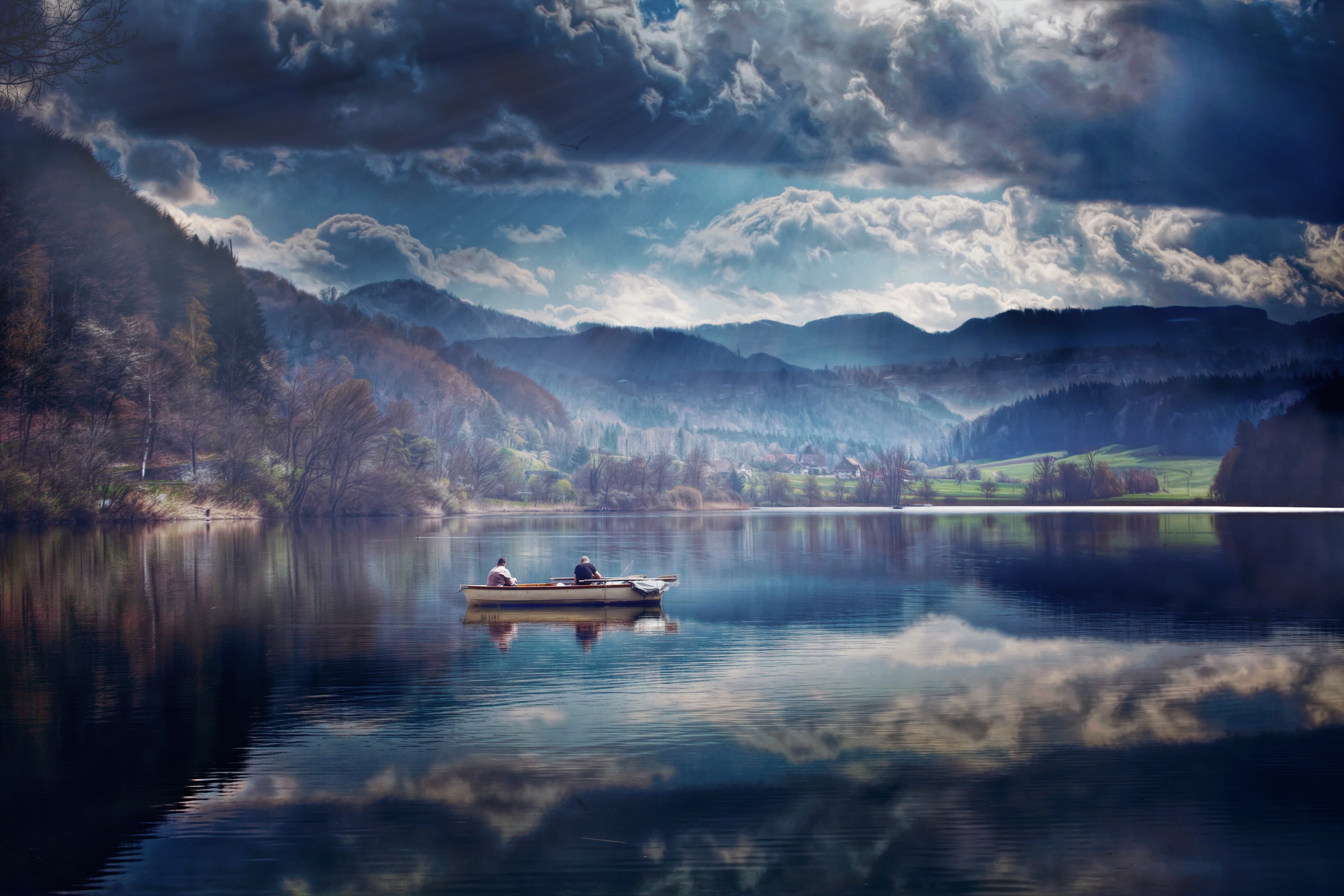 Two people in a boat on a lake in Switzerland HD Wallpaper