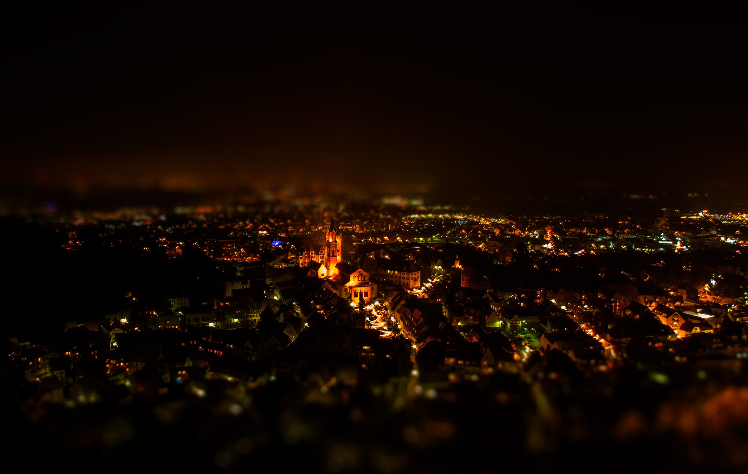 Cityscape at night from above with illuminated buildings HD Wallpaper