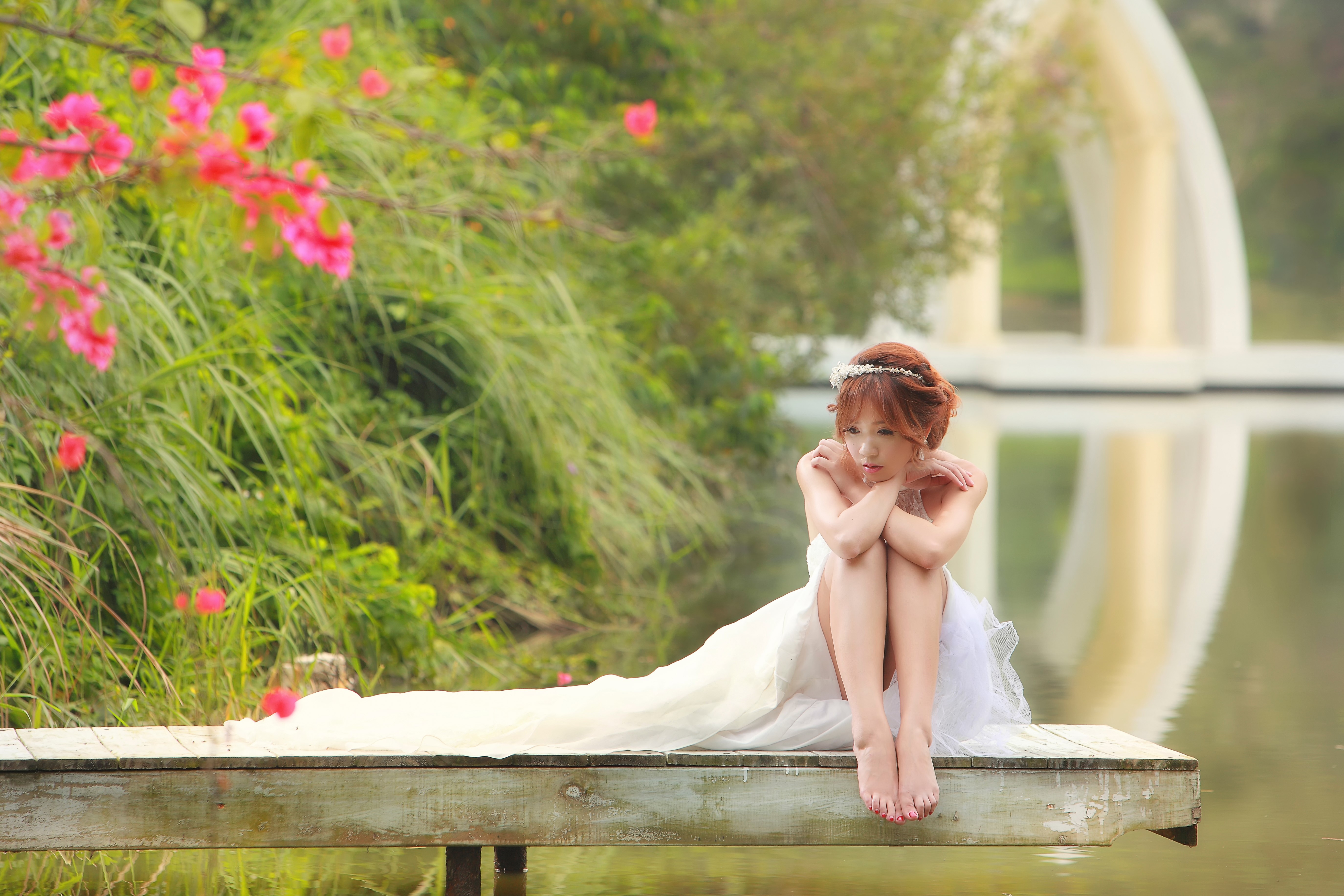 Serene Bride Sitting on Wooden Dock in Nature HD Wallpaper