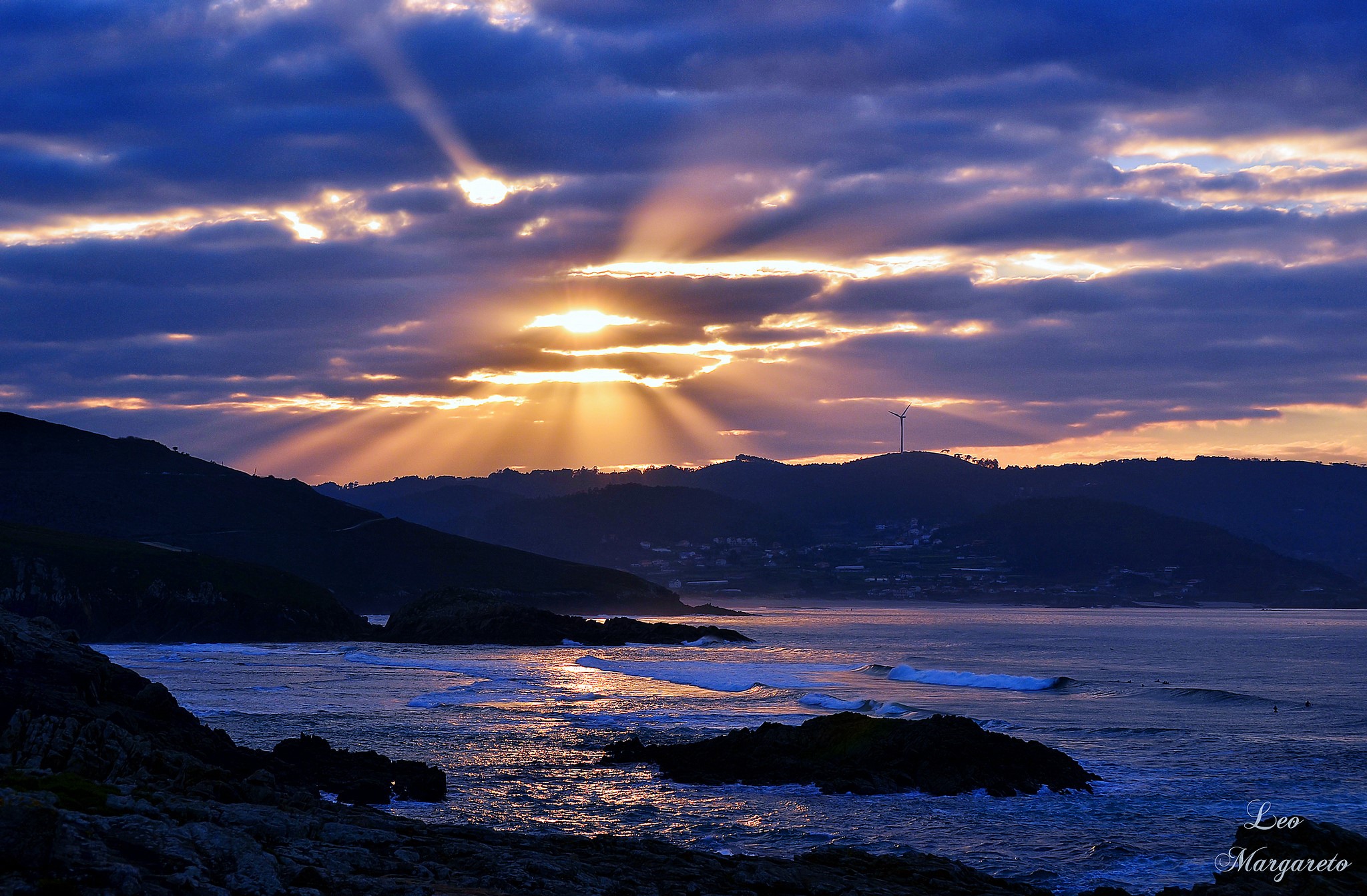 Sunset with sun rays over the sea and hills HD Wallpaper