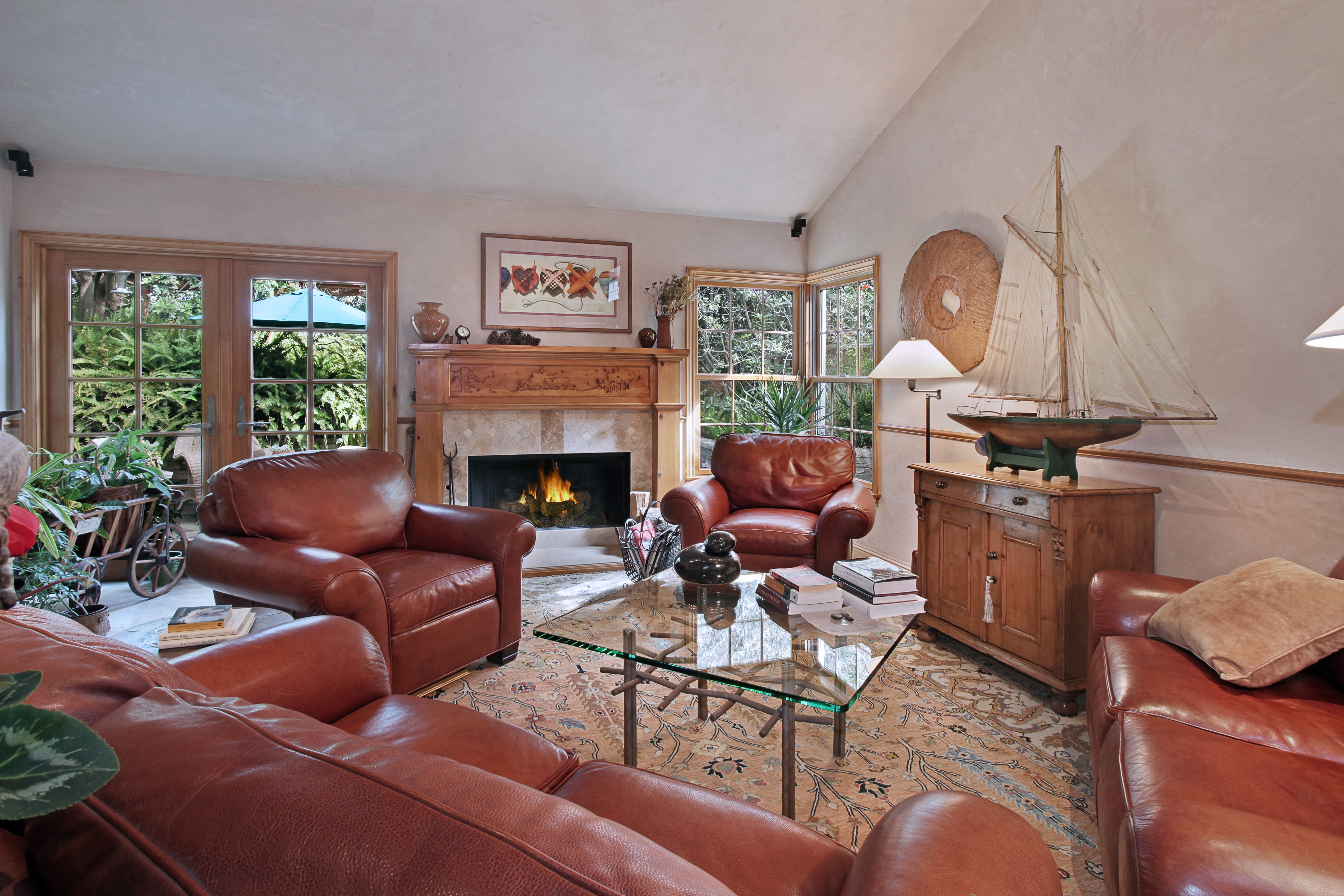 Living room with fireplace, sofa, and armchair HD Wallpaper