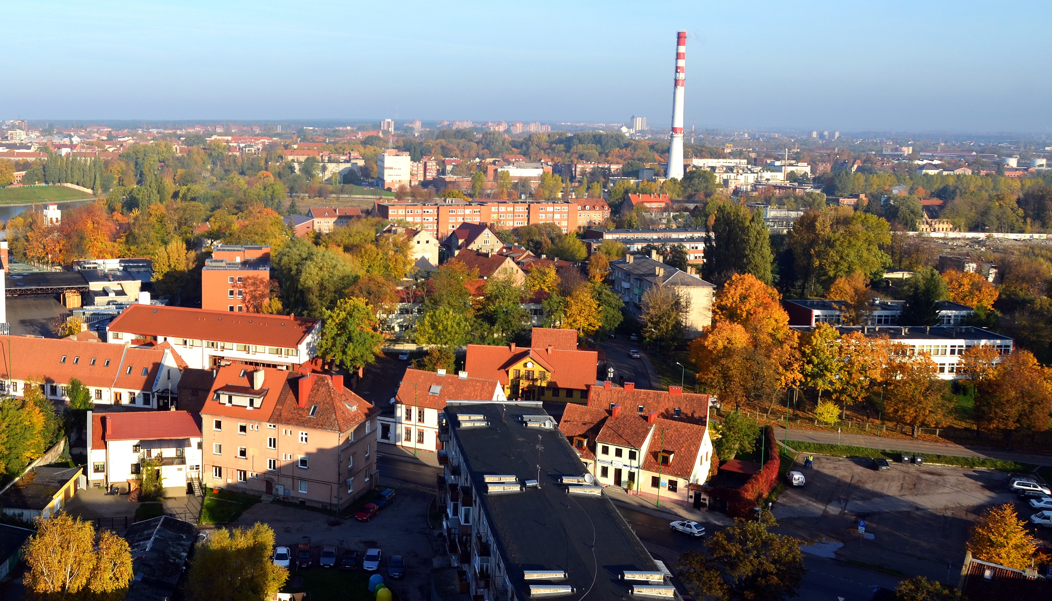 Cityscape with houses and a tall chimney in autumn HD Wallpaper