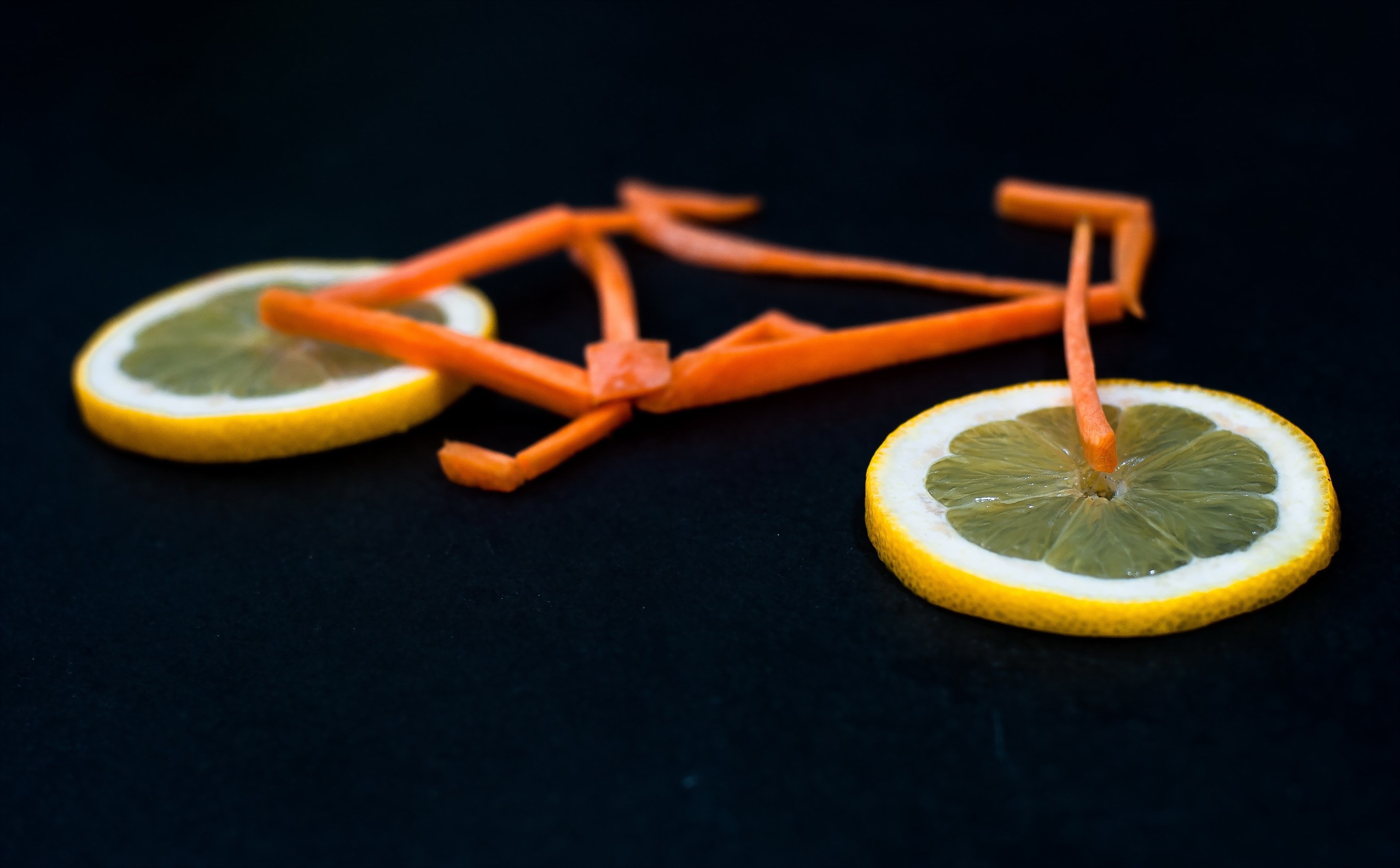 Creative bicycle made of carrots and lemons HD Wallpaper