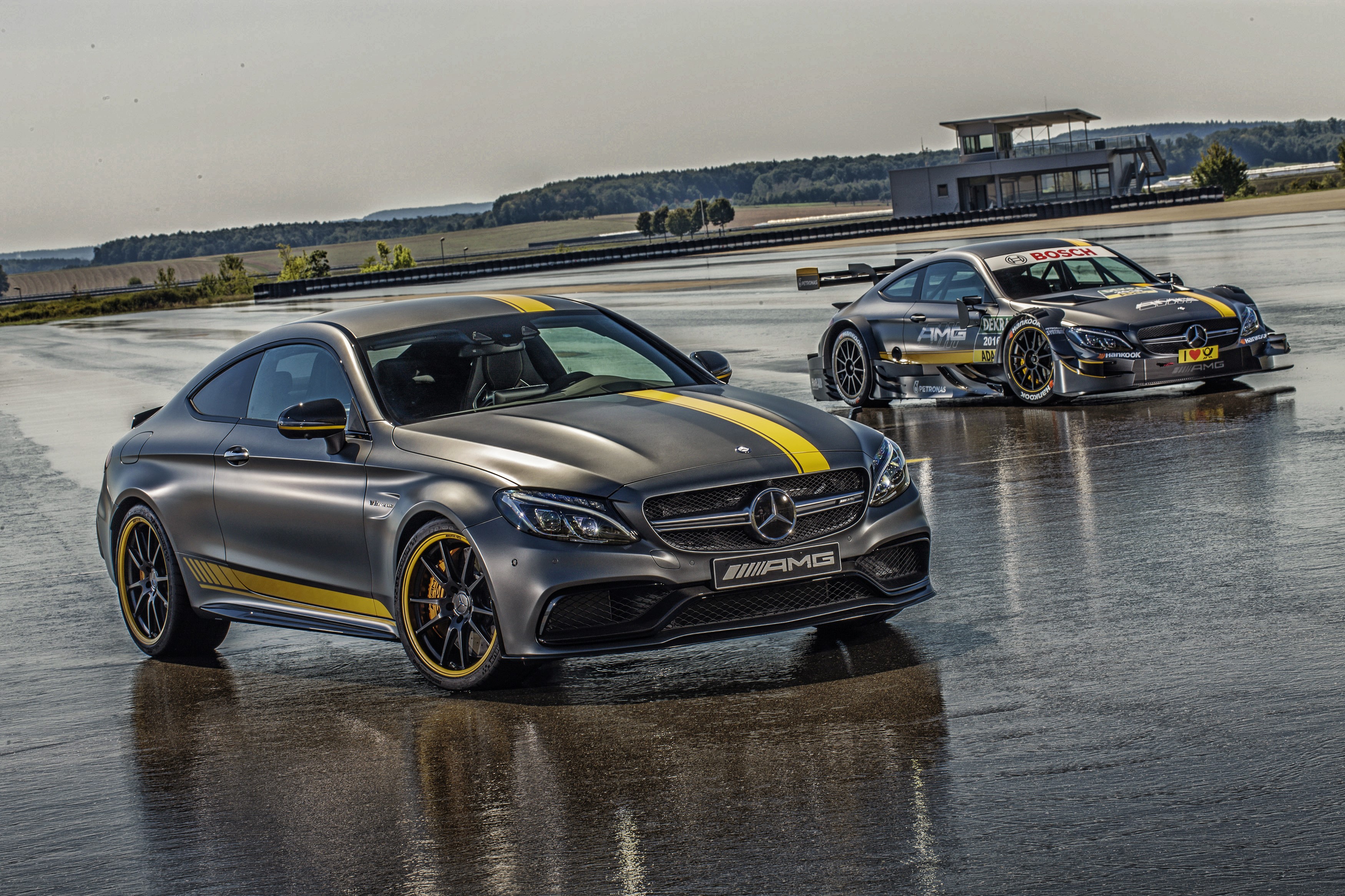 Two Mercedes-Benz AMG C 63 Coupe cars on a wet track HD Wallpaper
