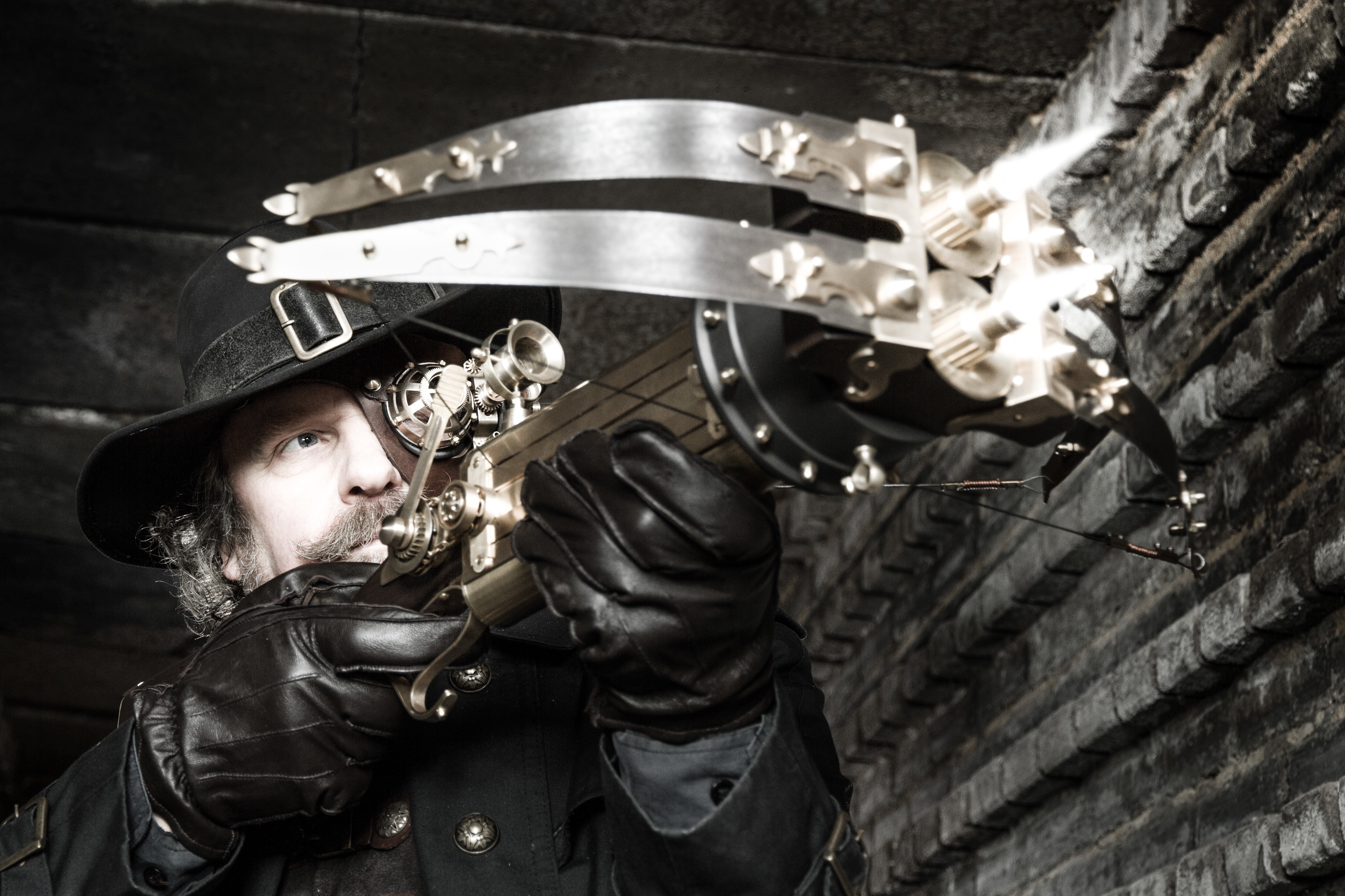 Man in Steampunk Hat with Crossbow HD Wallpaper