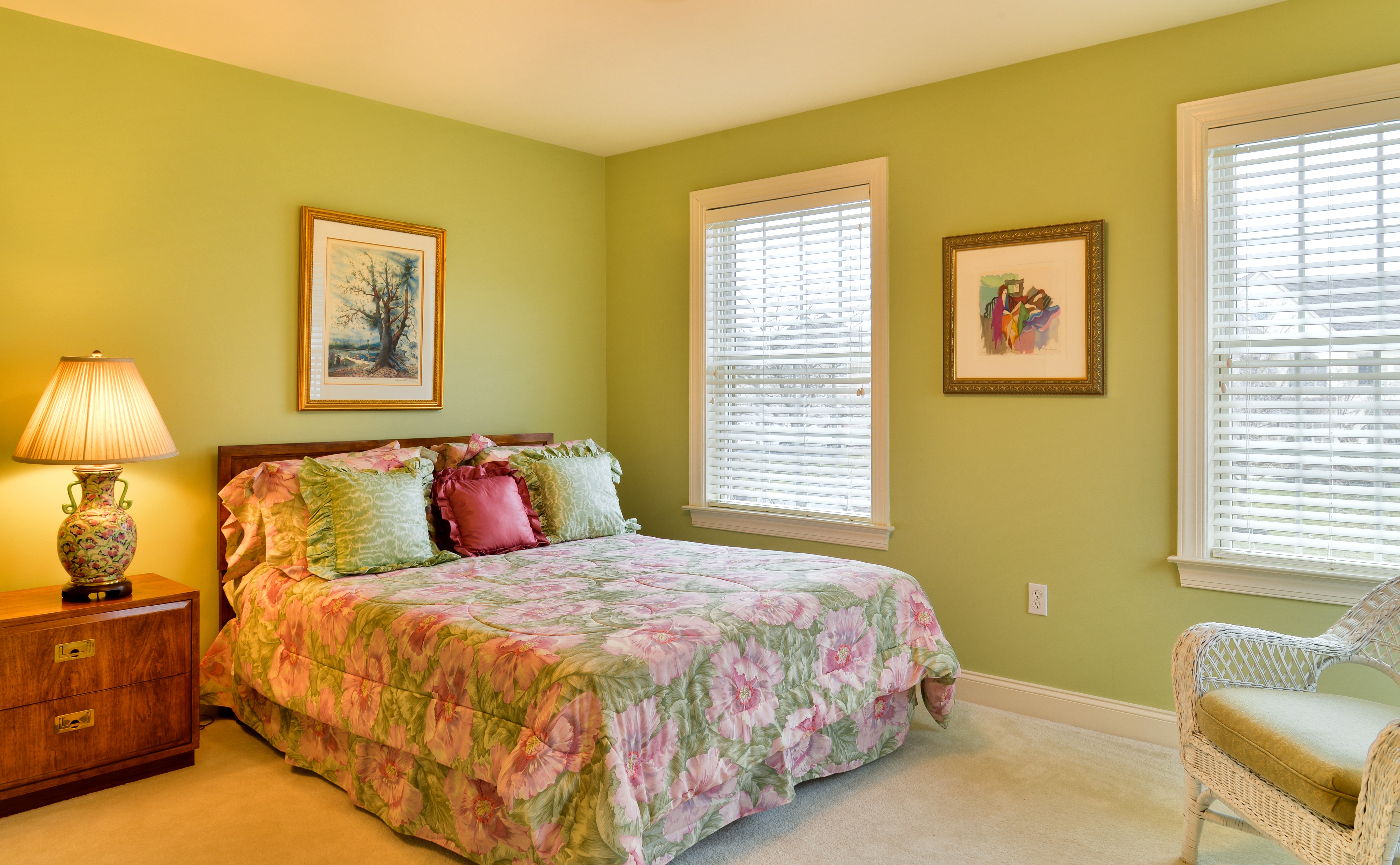 Bedroom with a bed, lamp, and paintings HD Wallpaper