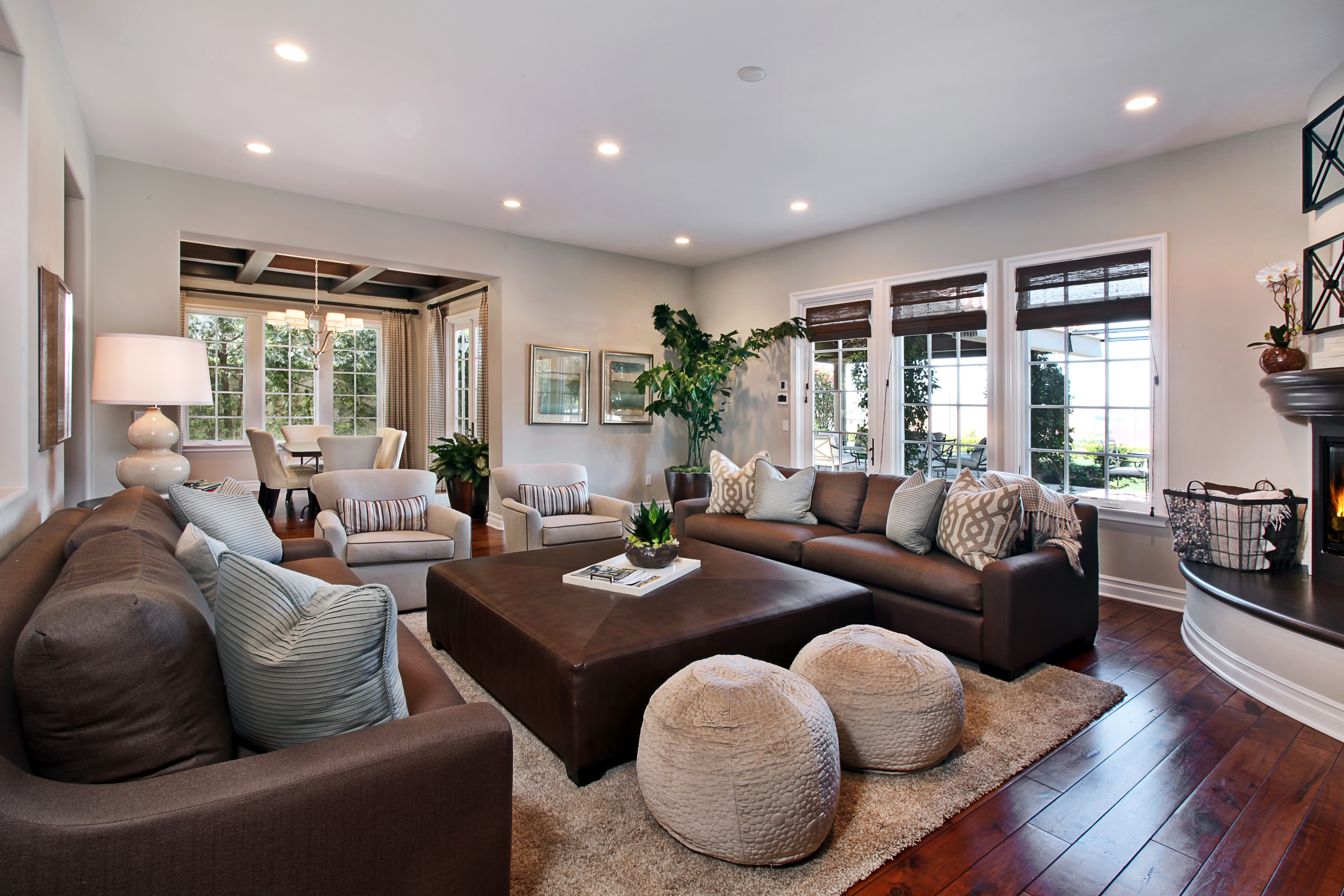 Living room with brown sofa and large ottoman HD Wallpaper