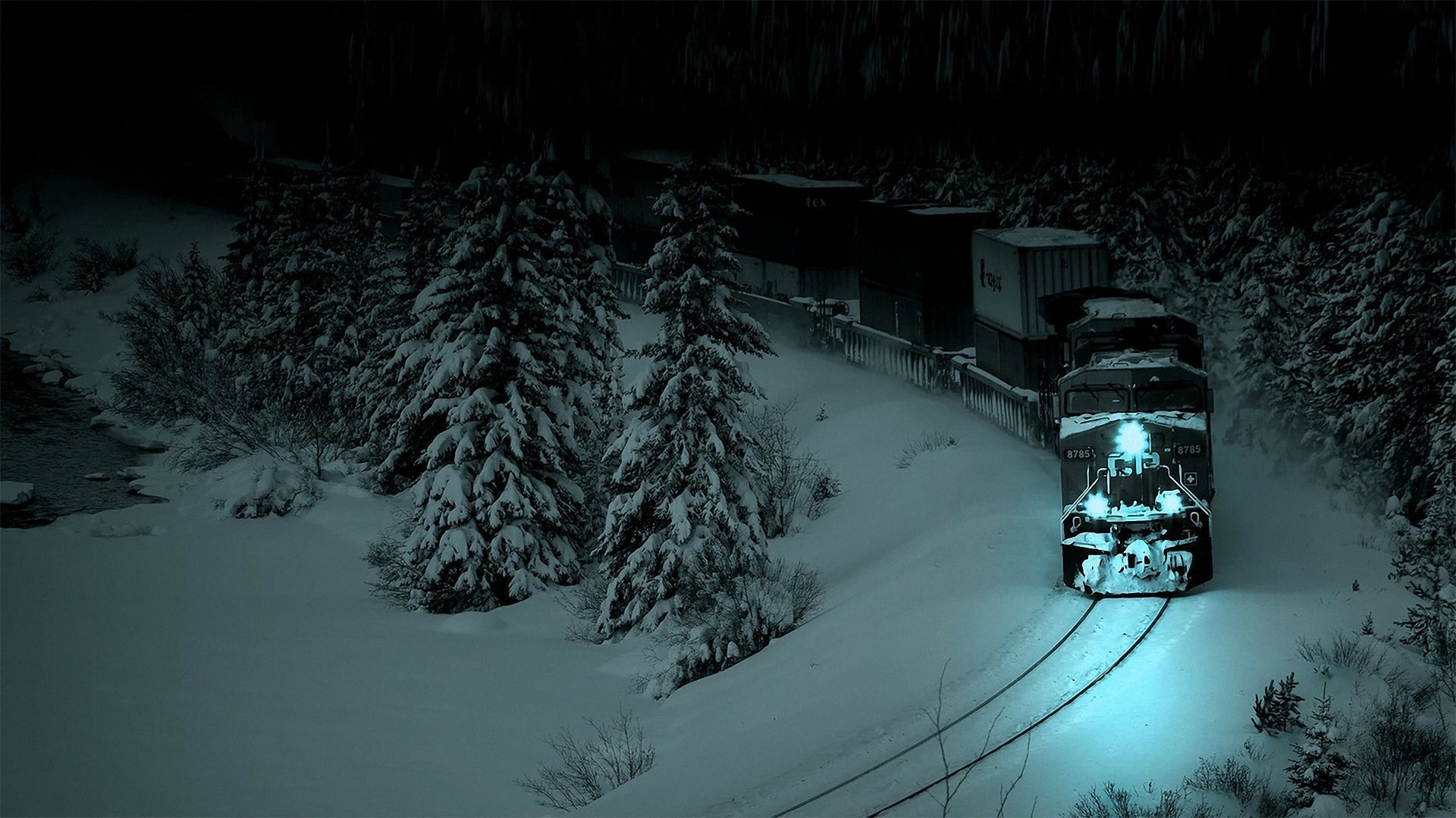Train in a snowy forest at night HD Wallpaper
