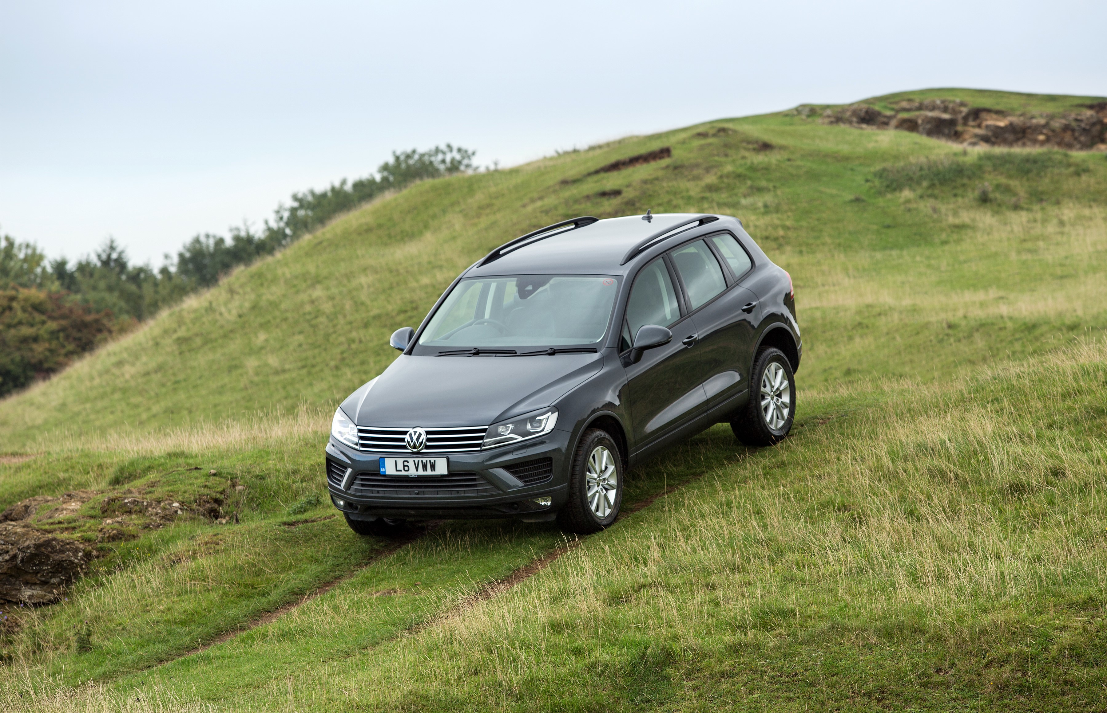 Volkswagen Touareg on a grassy hill HD Wallpaper