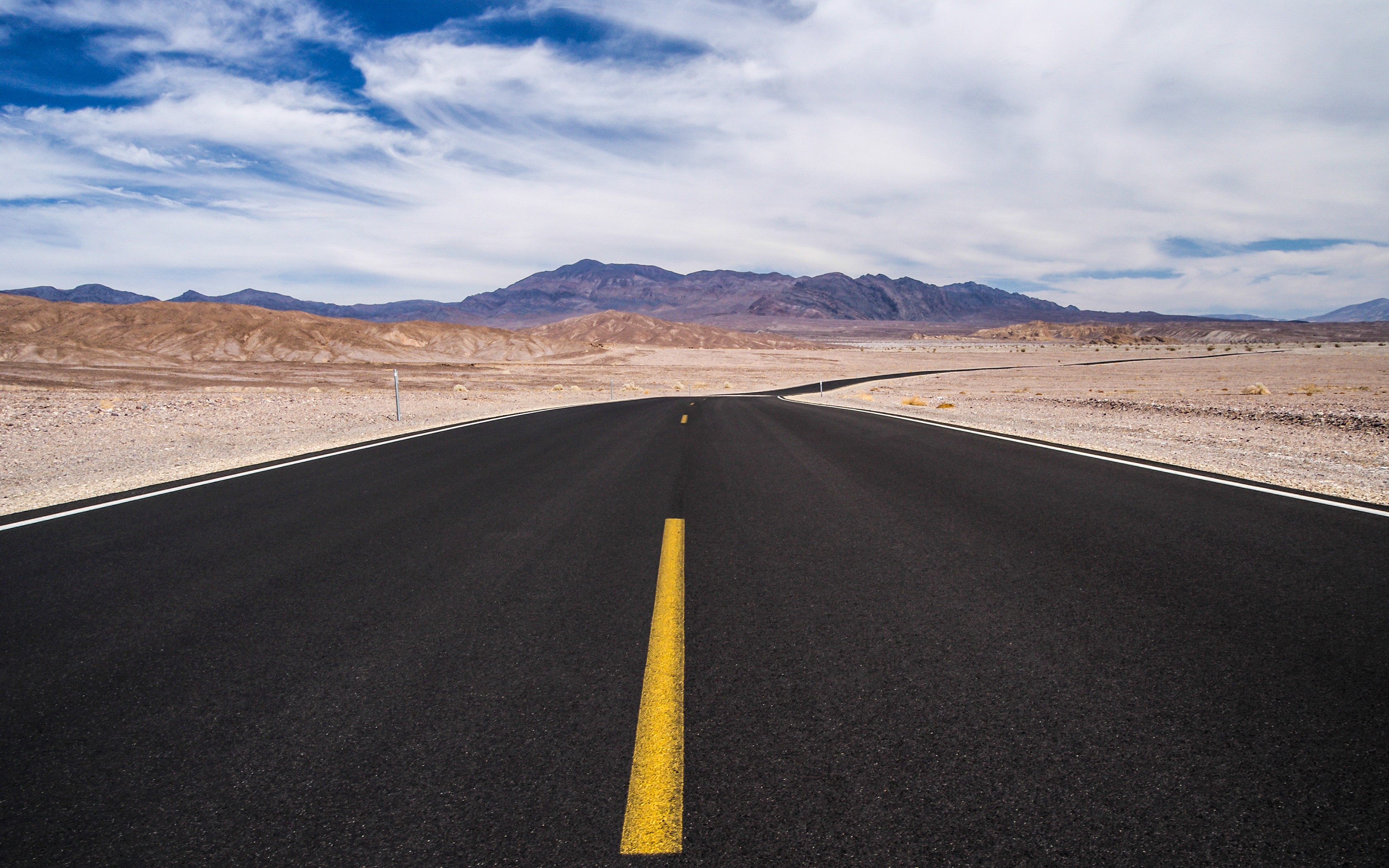 Asphalt road through Death Valley desert with mountains HD Wallpaper