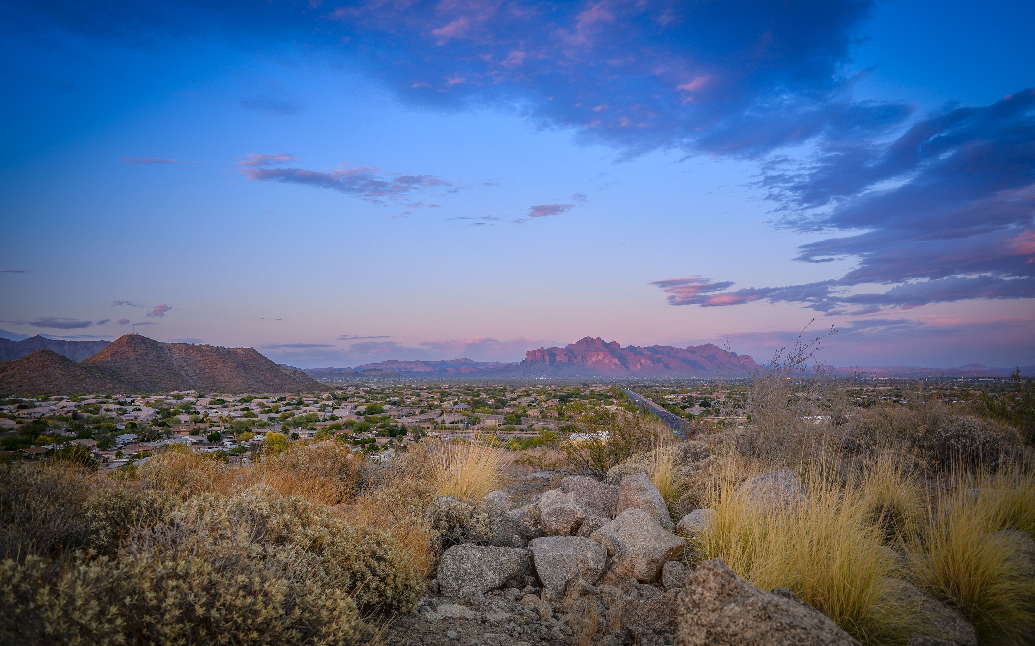 Desert landscape with mountains and houses at sunset HD Wallpaper