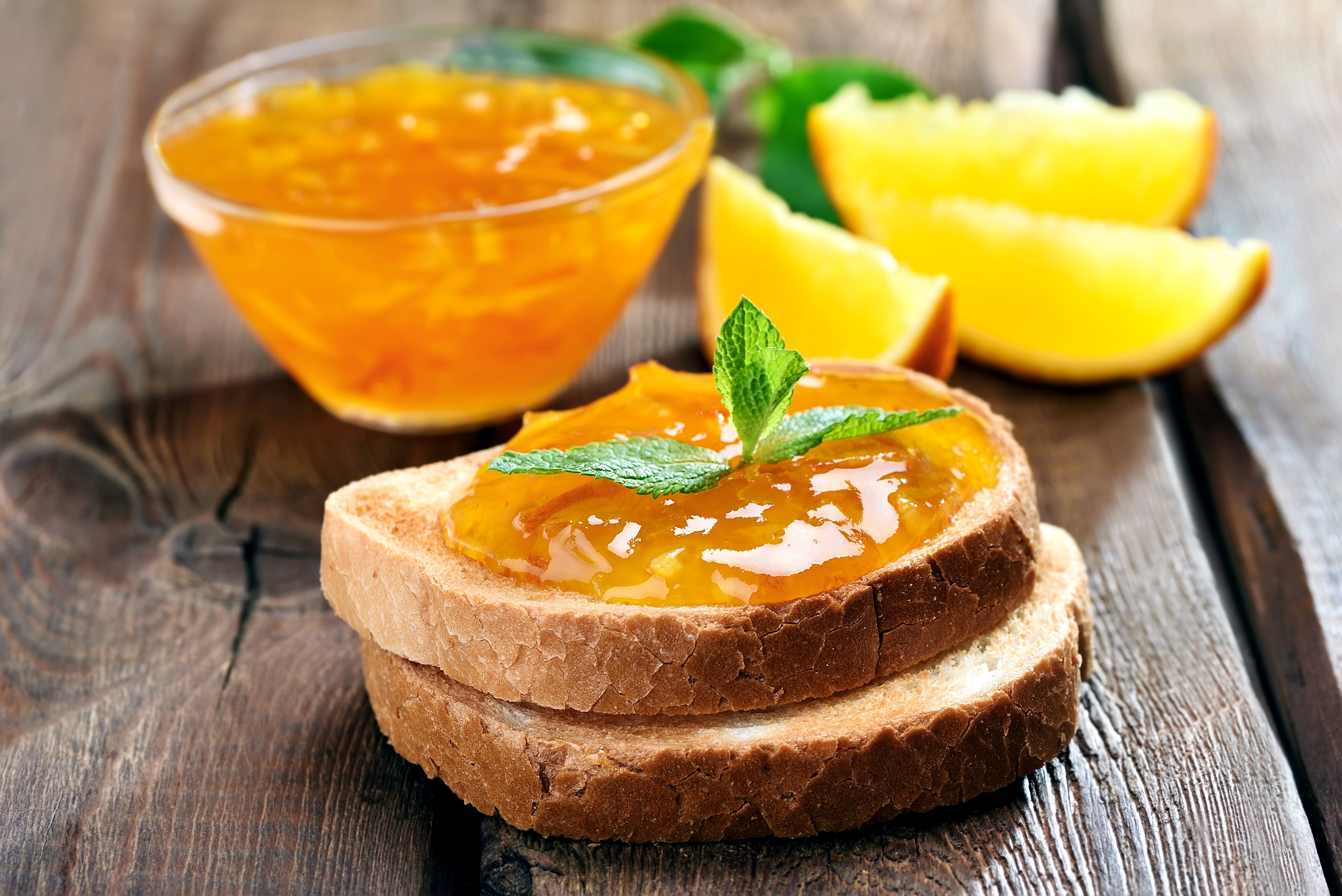 Orange jam on toast with mint and orange slices HD Wallpaper
