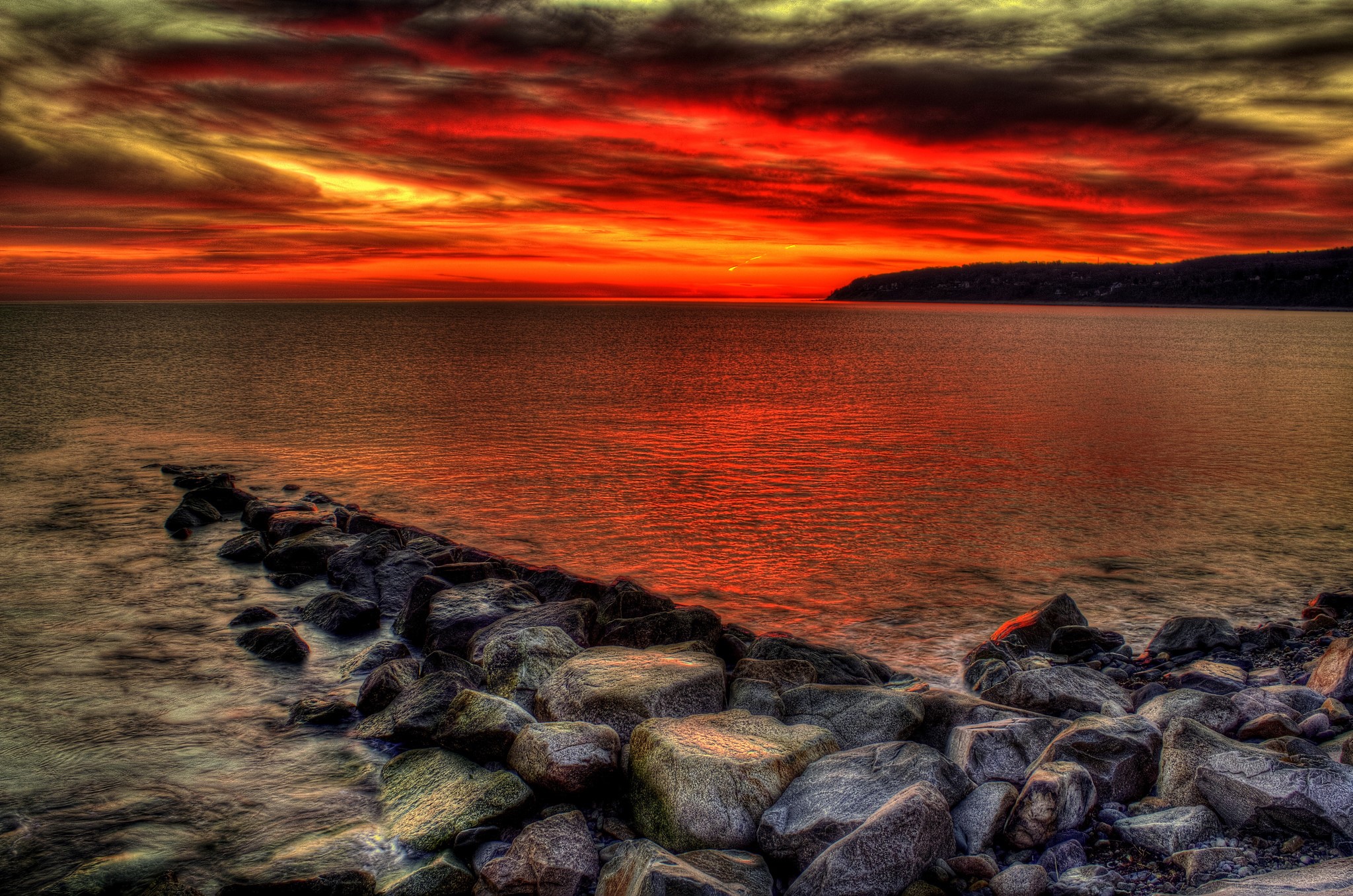 Sunset over the ocean with a rocky shore HD Wallpaper