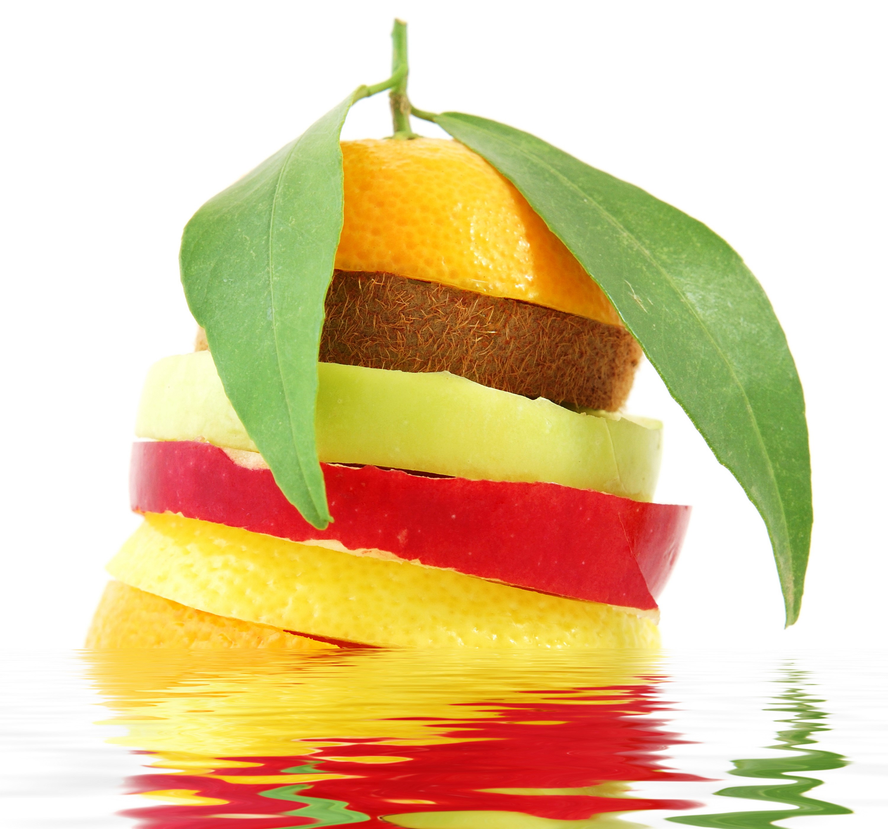 Stack of sliced fruits with leaves and reflection HD Wallpaper
