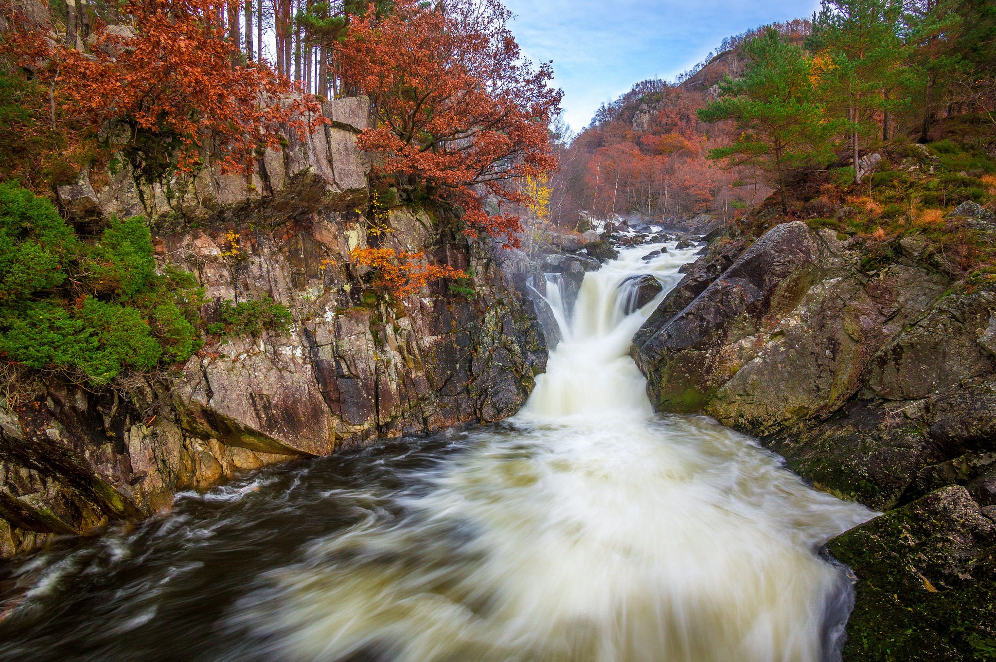 Waterfall in a rocky forest during autumn HD Wallpaper