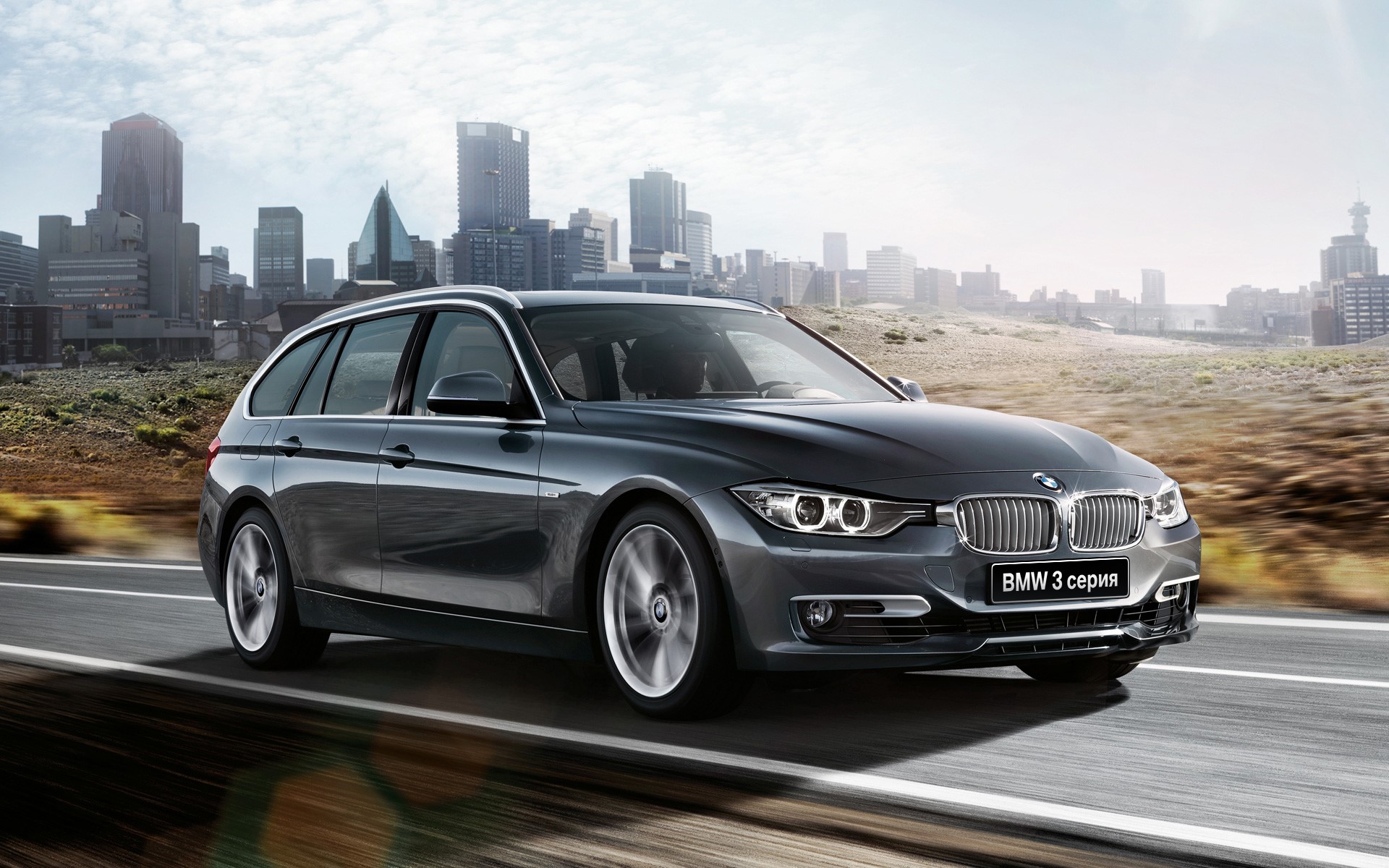 BMW 3 Series Touring car on a road HD Wallpaper