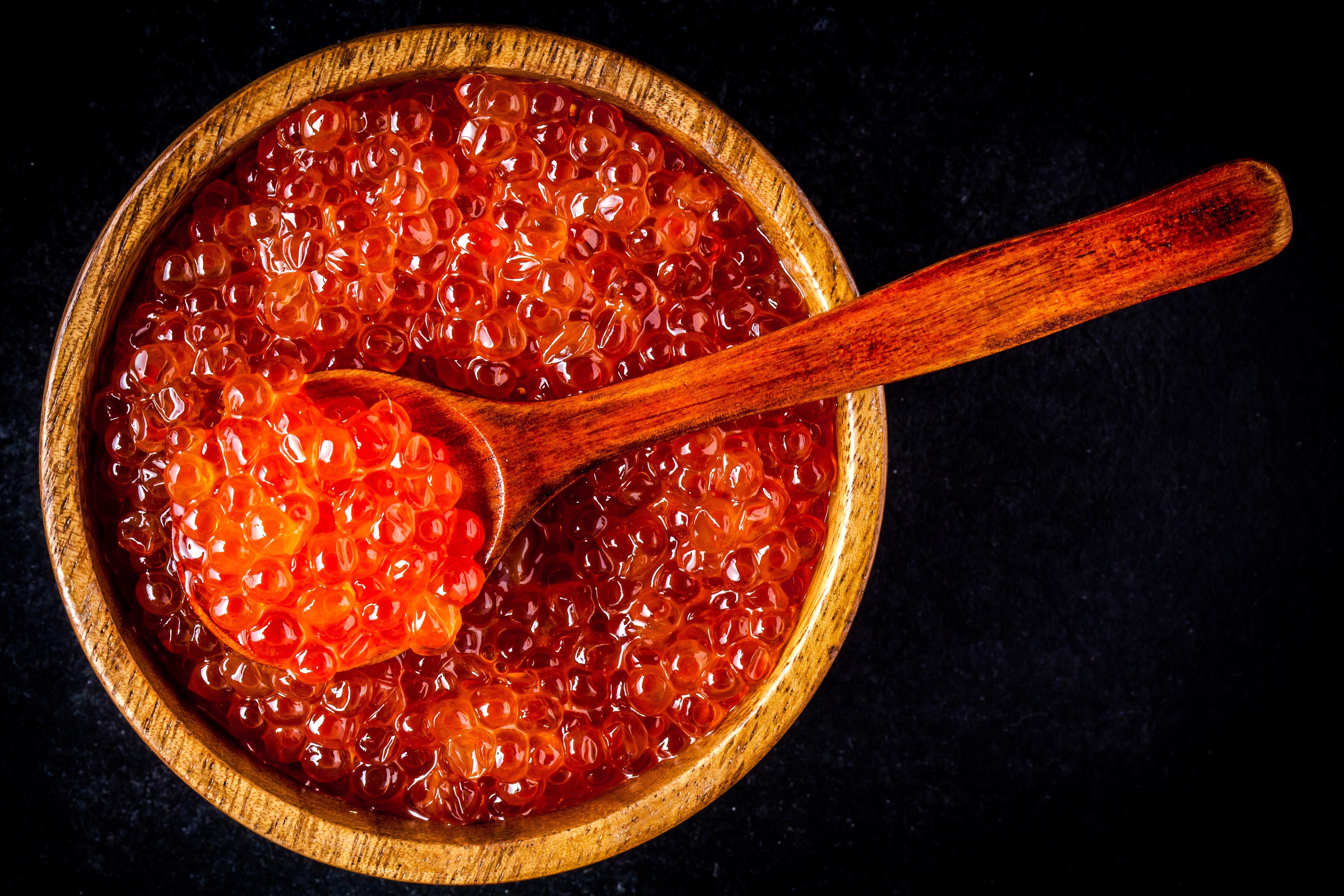 Red caviar in a wooden bowl with a spoon HD Wallpaper