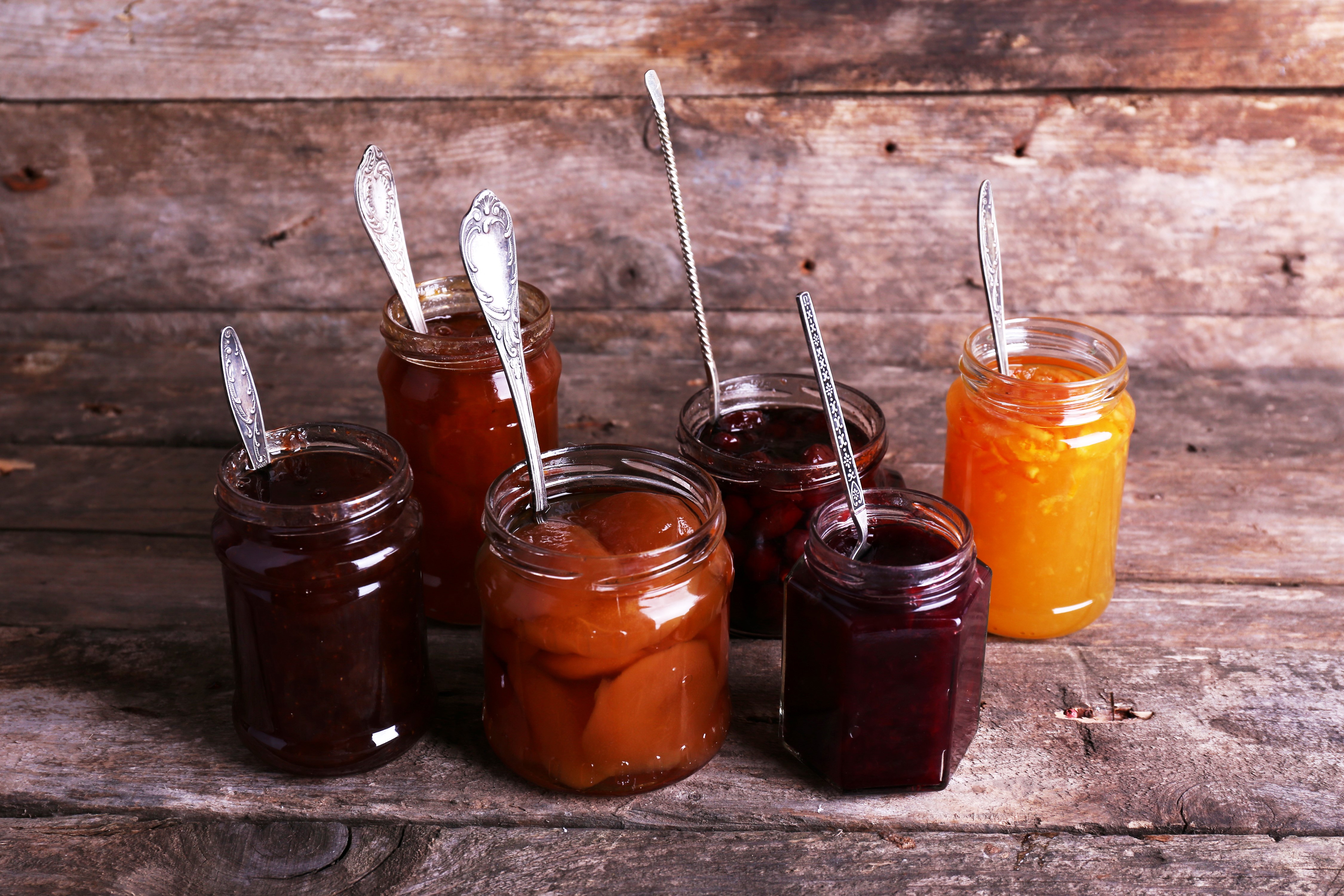 Jars of jam with spoons on wooden background HD Wallpaper
