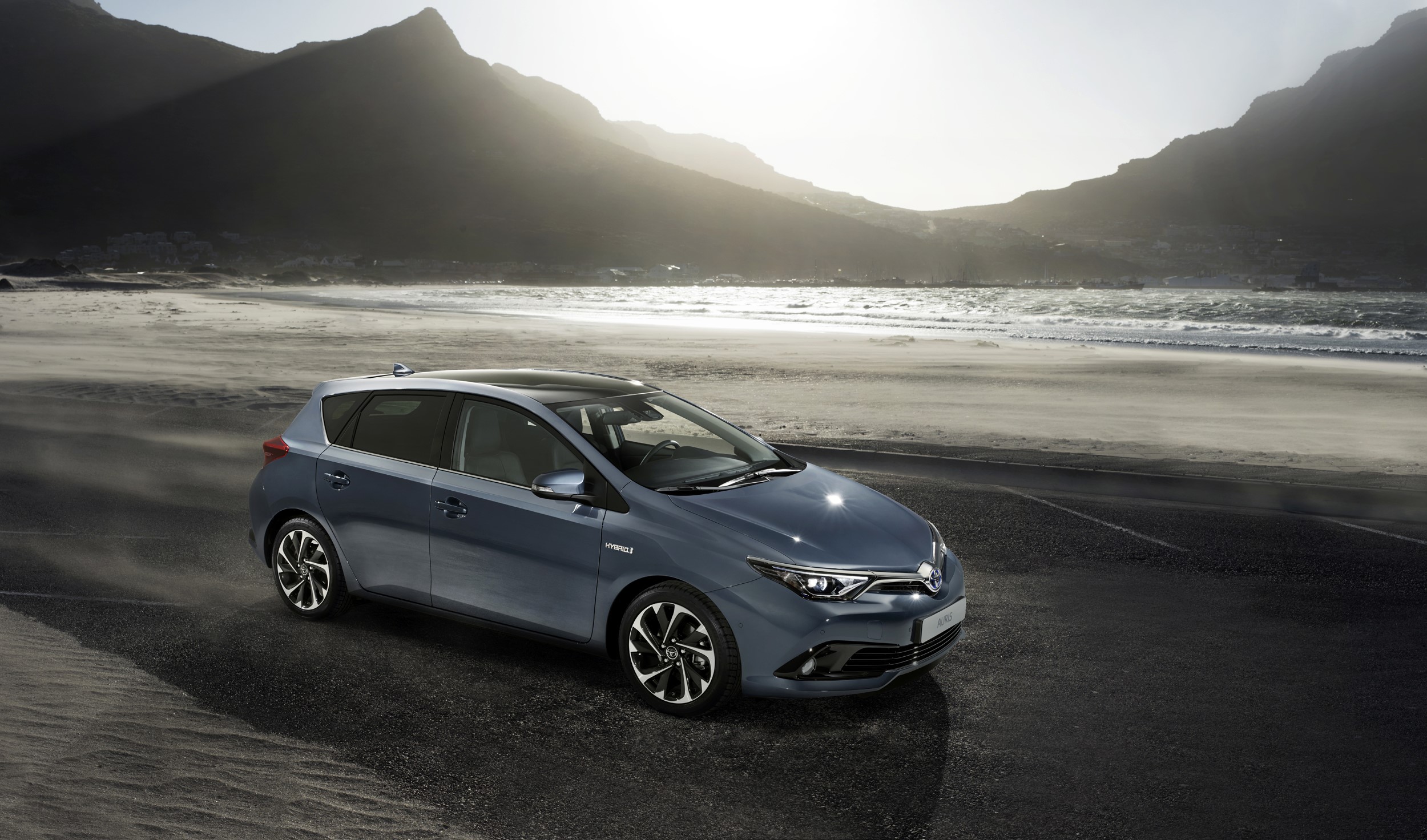 2015 Toyota Auris Hybrid on a beach with mountains HD Wallpaper