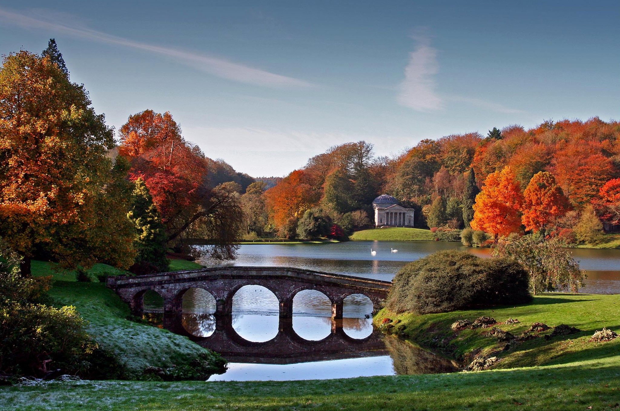 Stone bridge over a lake with autumn trees and a temple HD Wallpaper