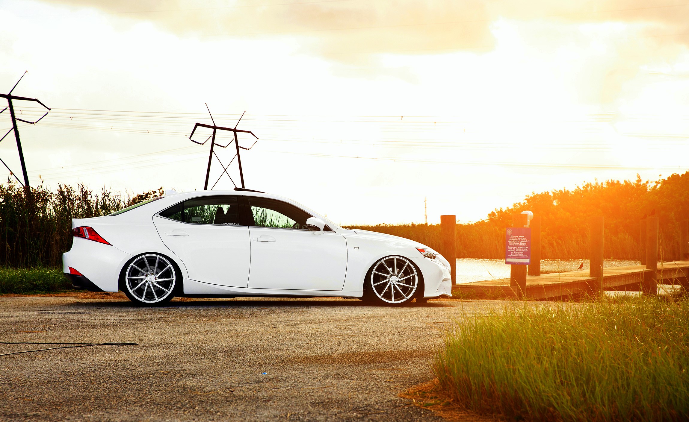 White Lexus IS F-sport parked by a dock HD Wallpaper
