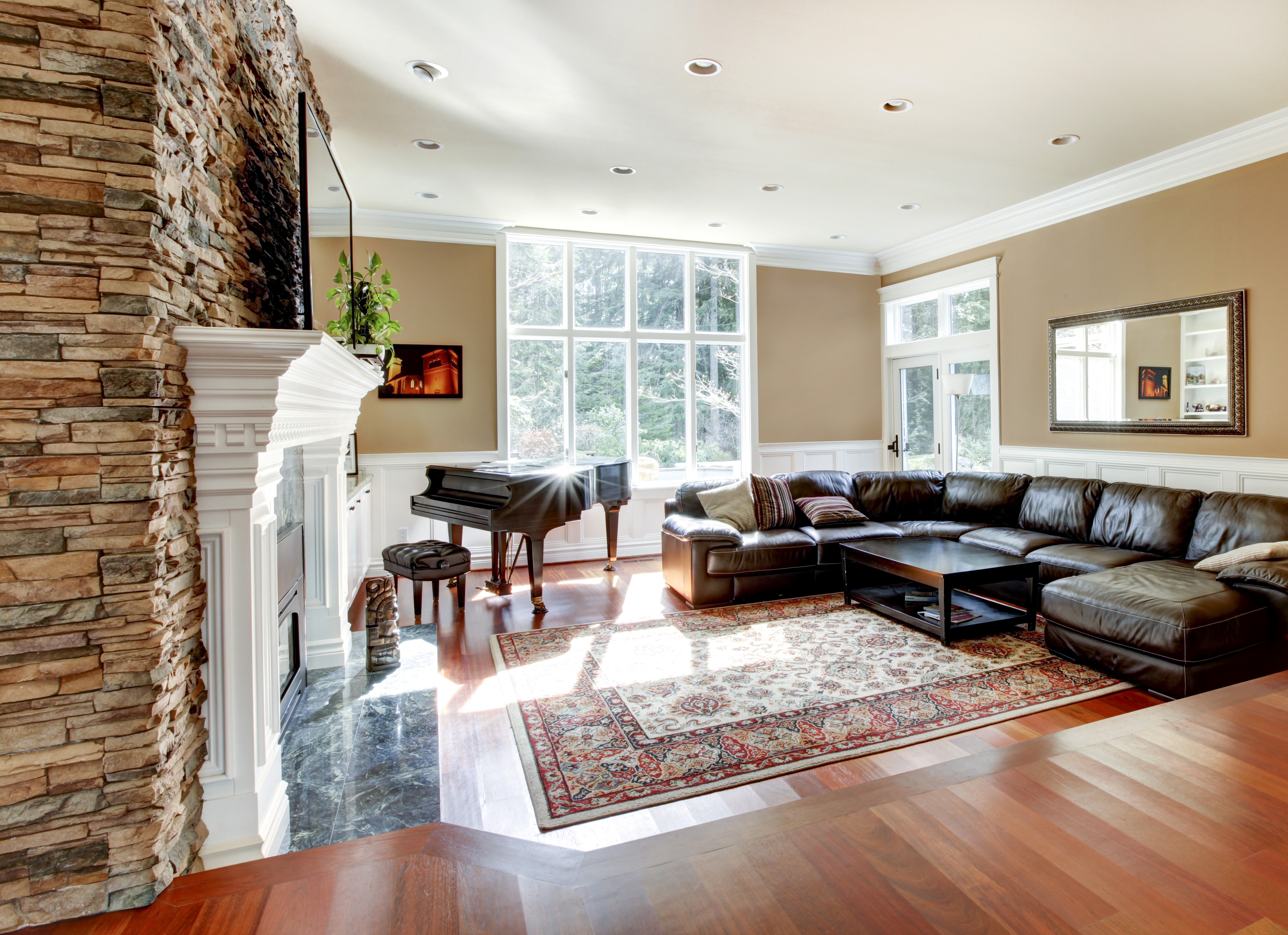 Living room with piano, sofa, and stone fireplace HD Wallpaper