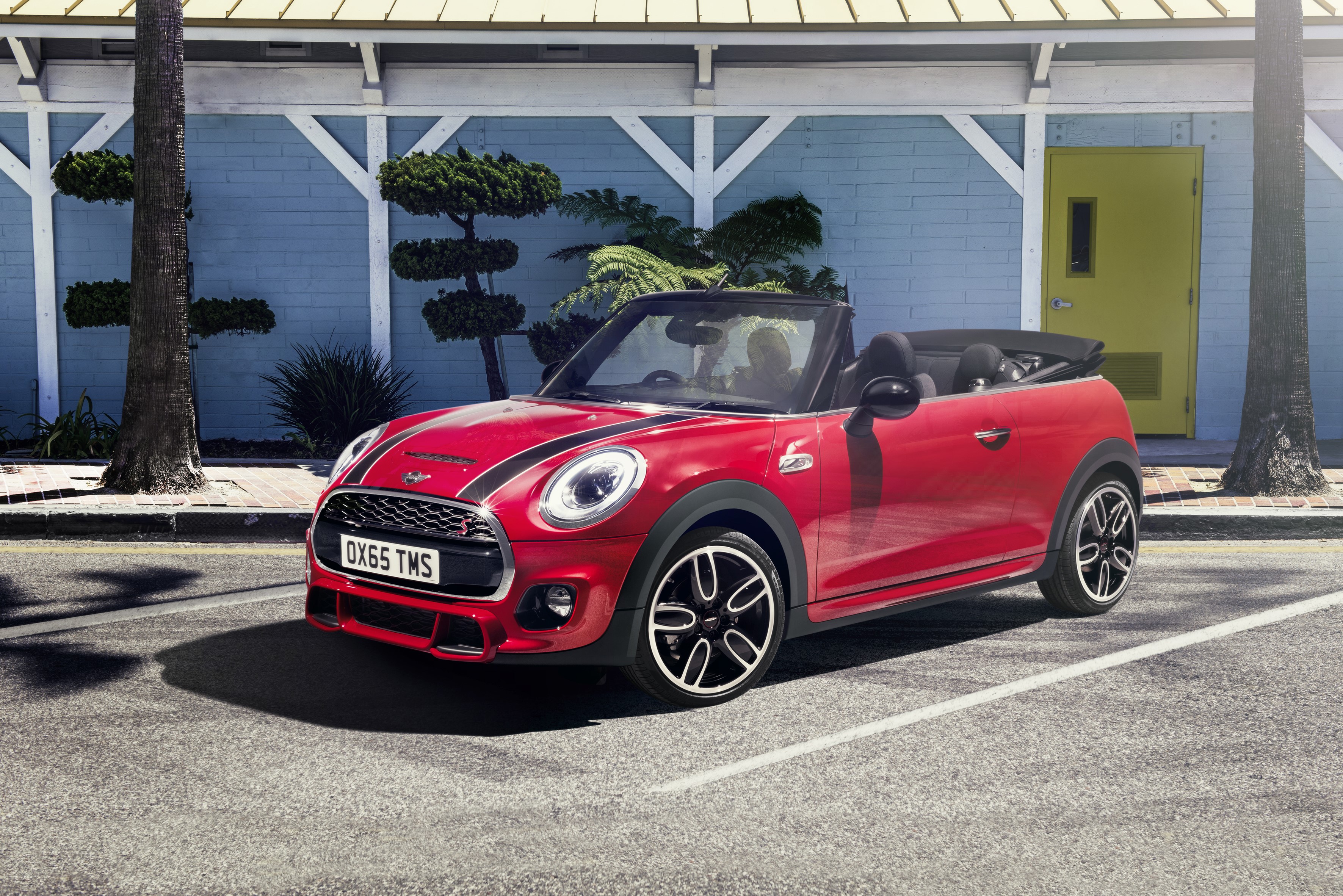 Red Mini Cooper S Convertible parked outside a blue building HD Wallpaper