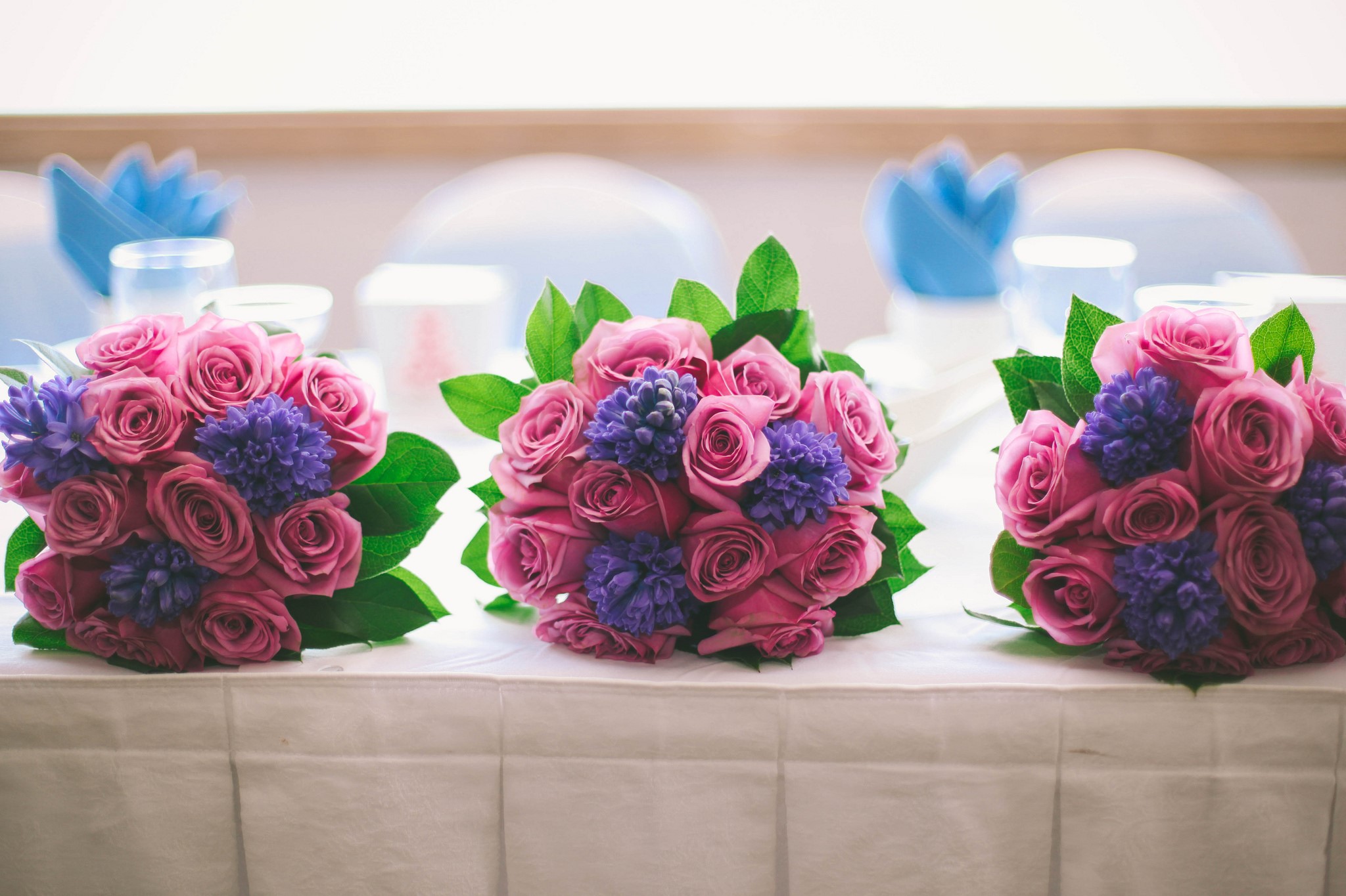 Three pink rose and purple hyacinth bouquets on a table HD Wallpaper
