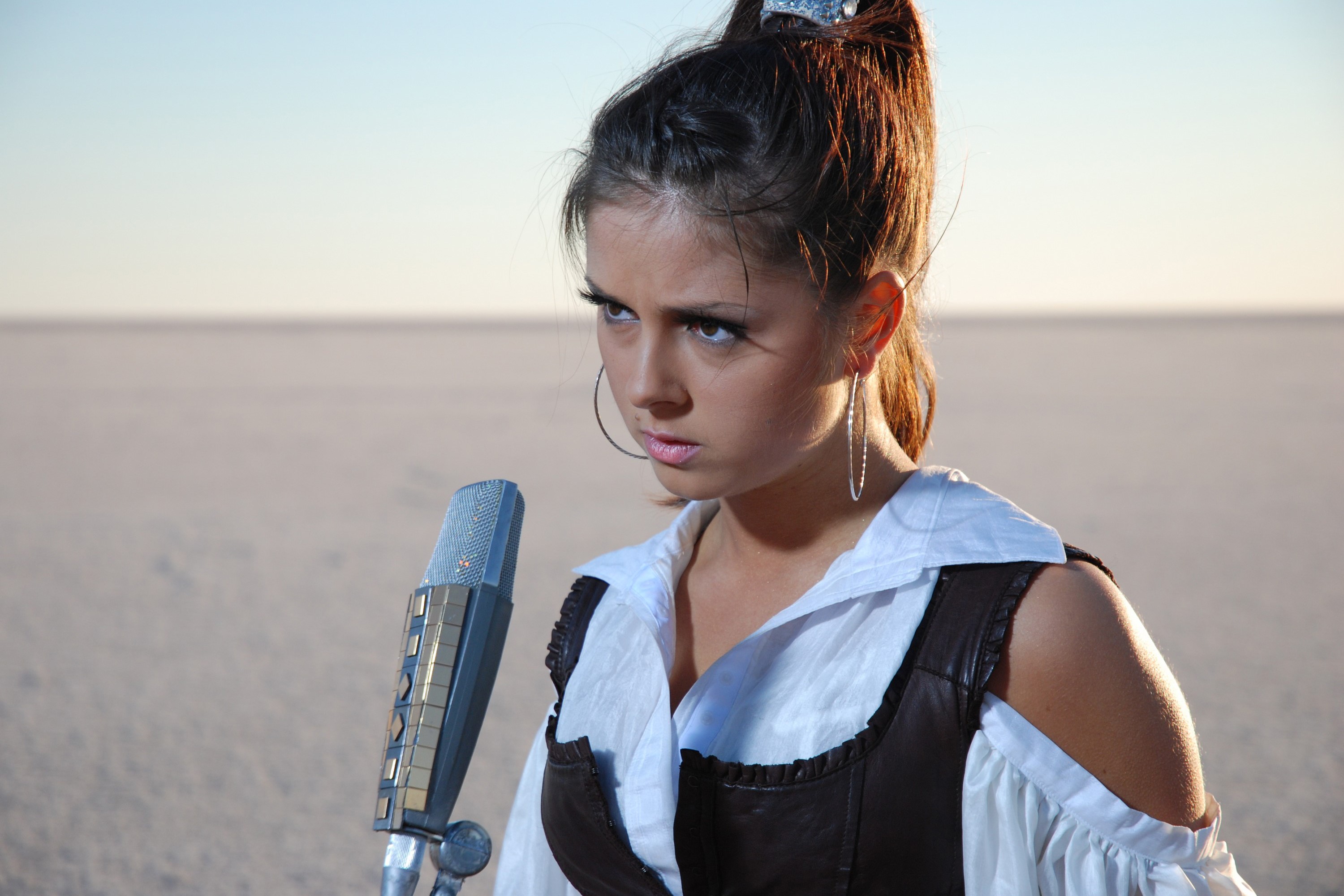 Nyusha with a microphone in a desert HD Wallpaper