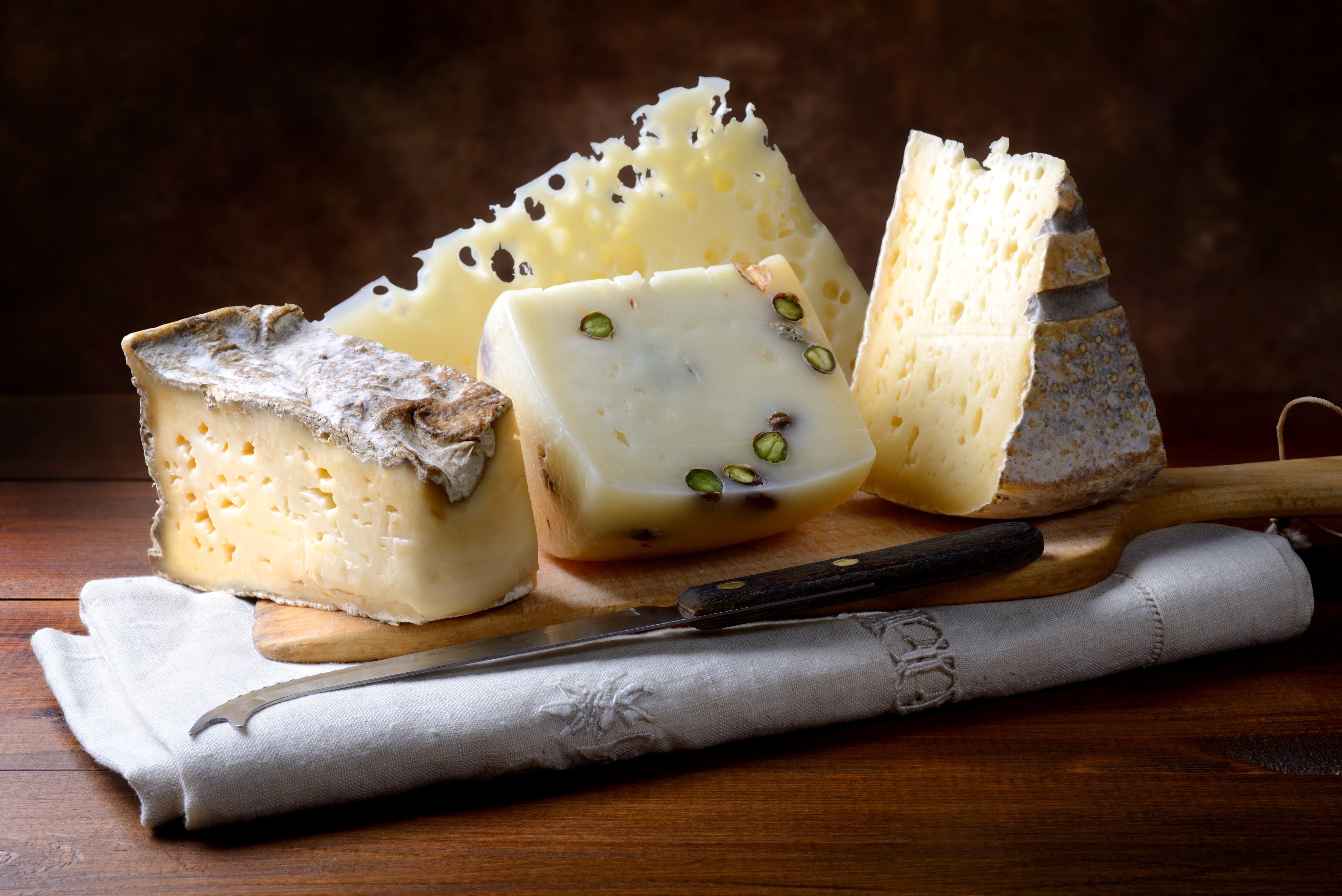 Assortment of cheeses with a knife HD Wallpaper