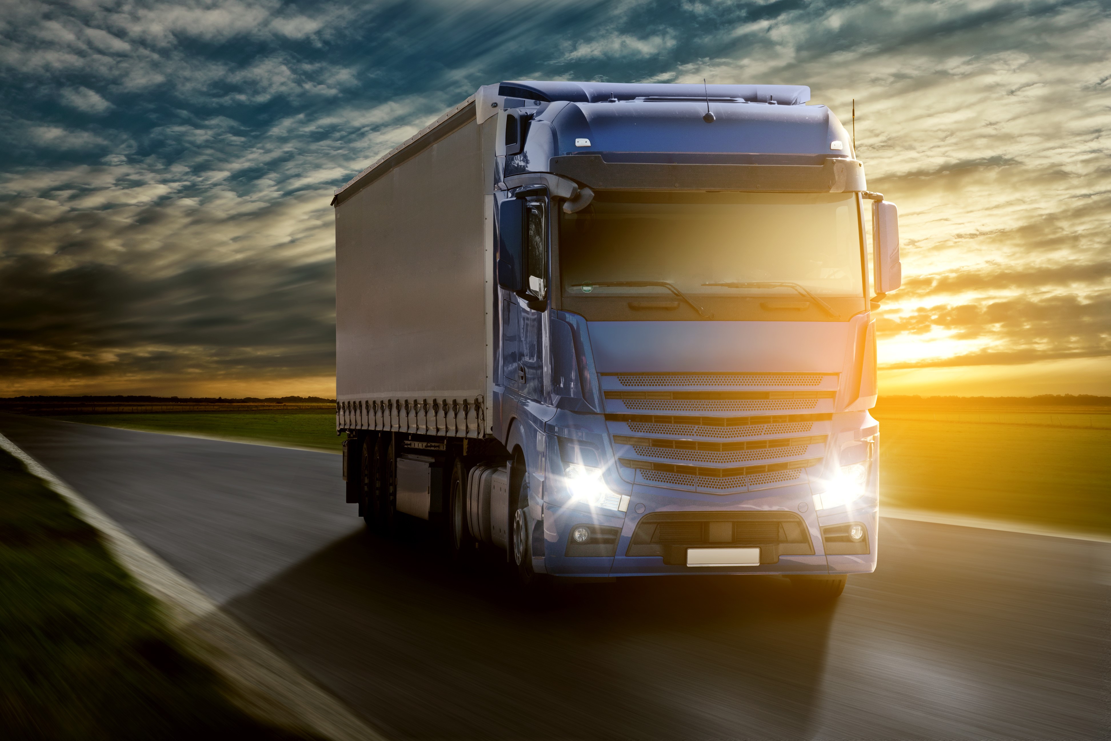Blue truck driving on a road at sunset HD Wallpaper
