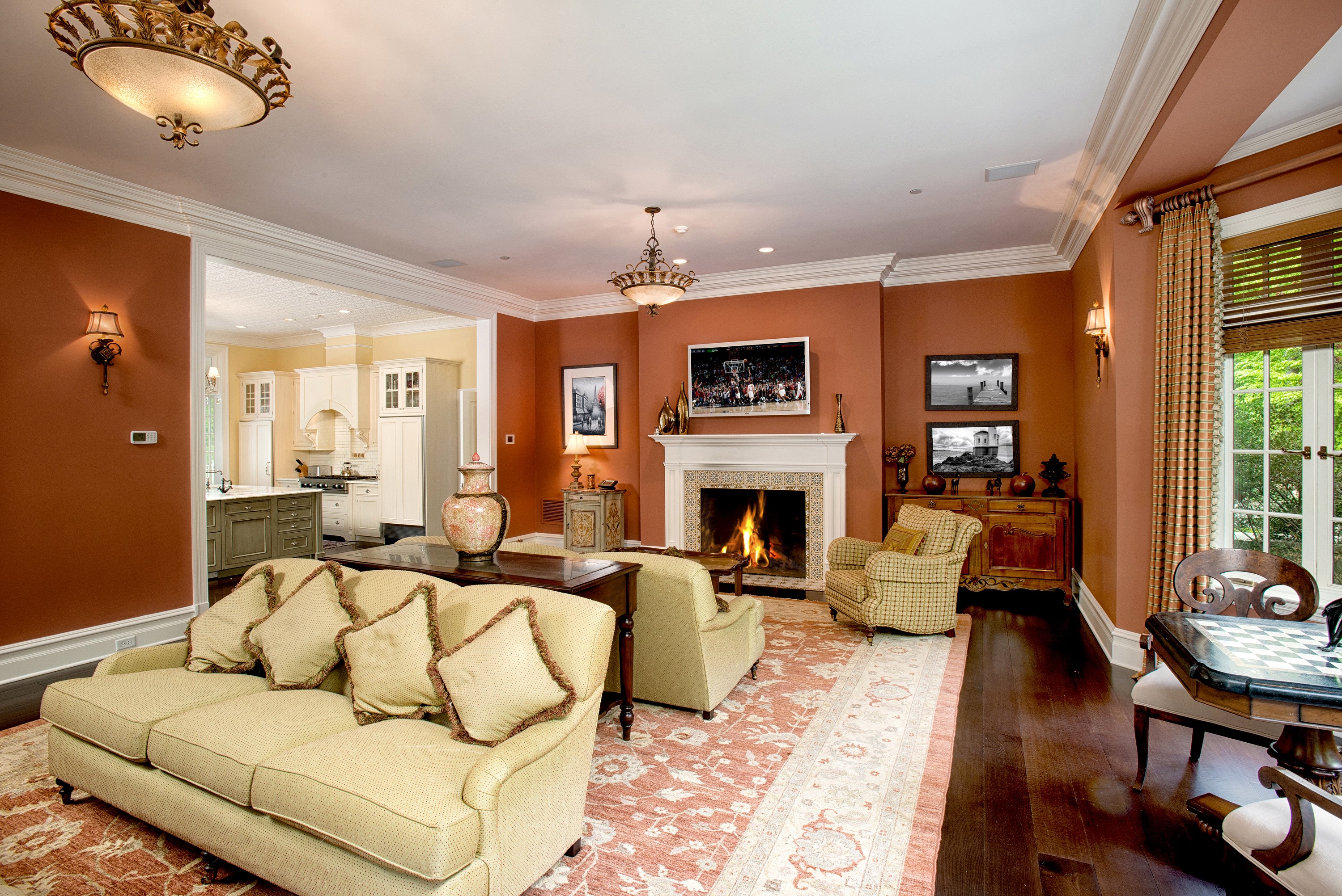 Living room with fireplace, sofa, and kitchen view HD Wallpaper