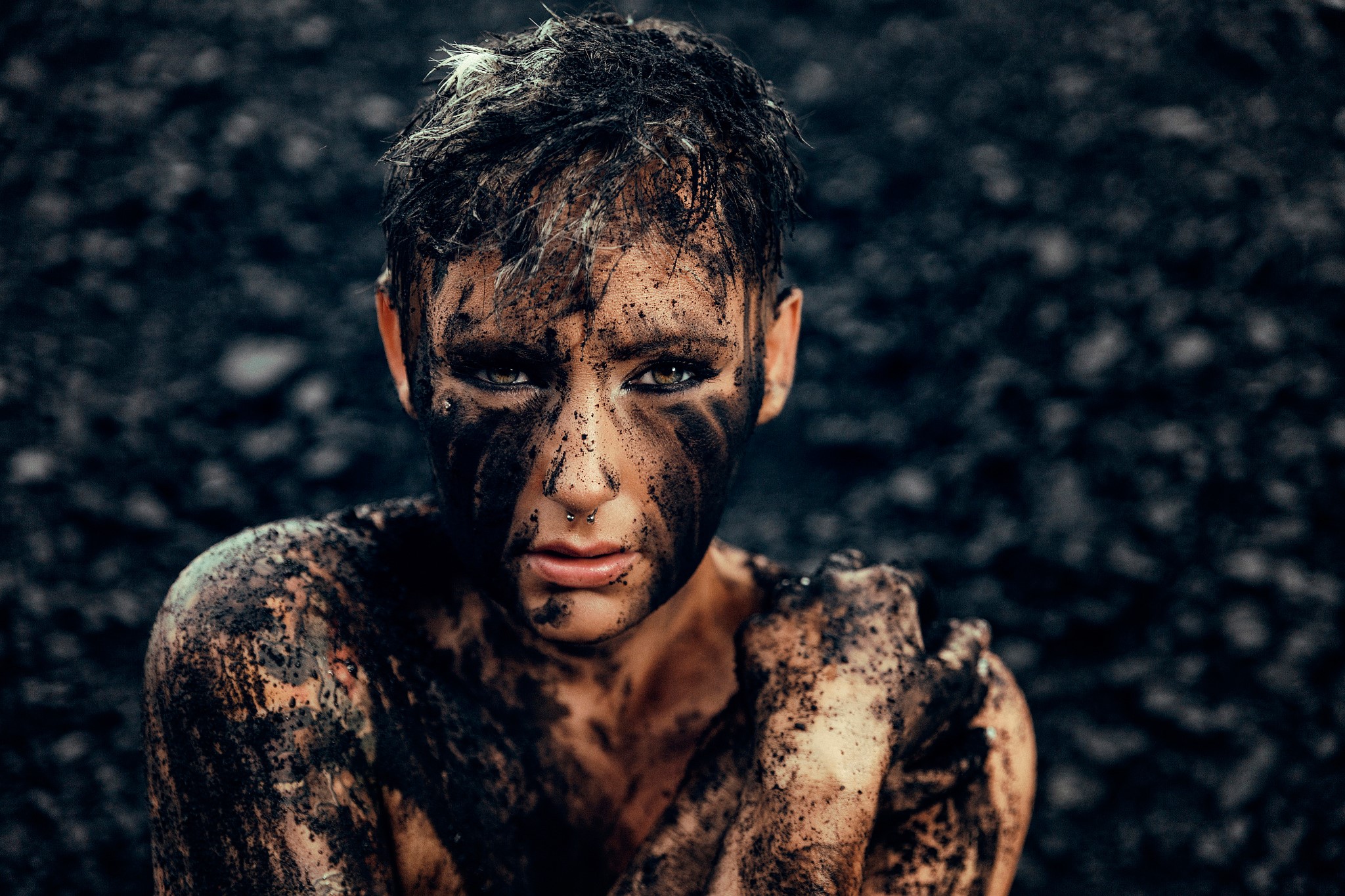 Person covered in mud with dark background HD Wallpaper