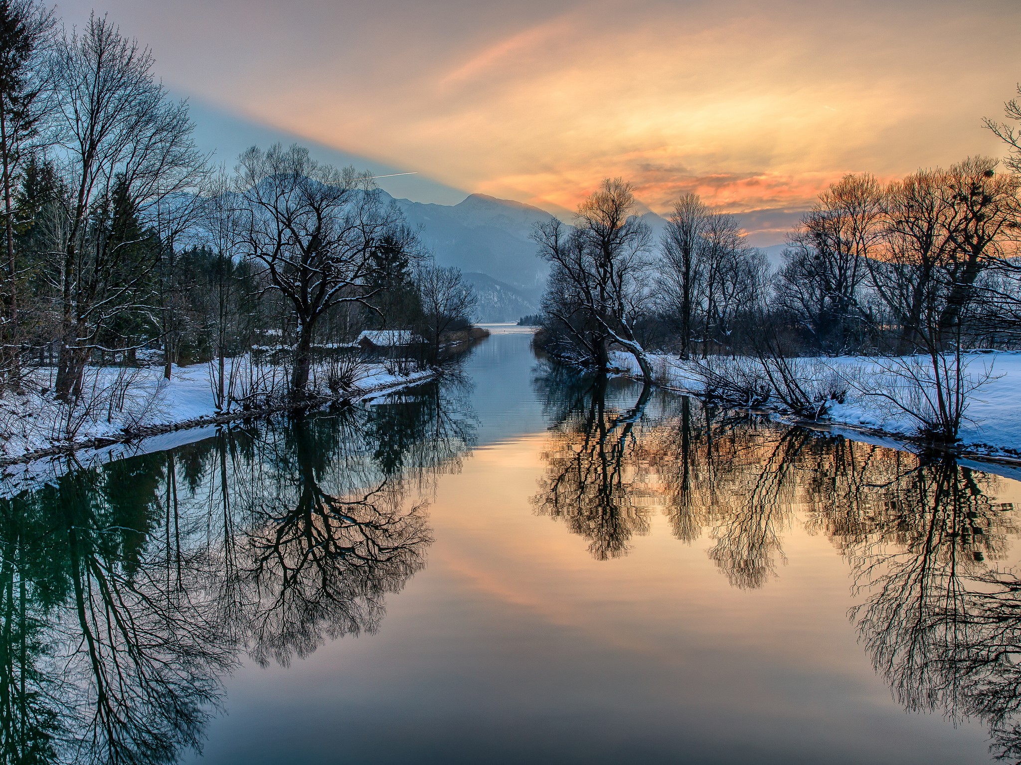 Winter river reflecting trees and mountains at sunset HD Wallpaper