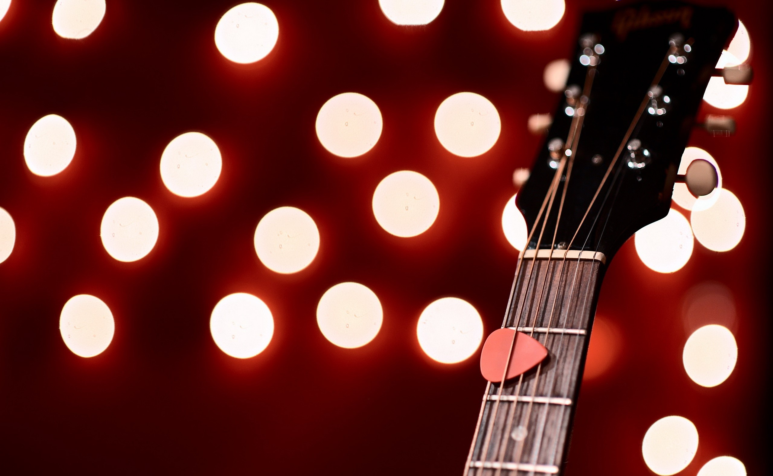Guitar headstock with pick and bokeh lights HD Wallpaper