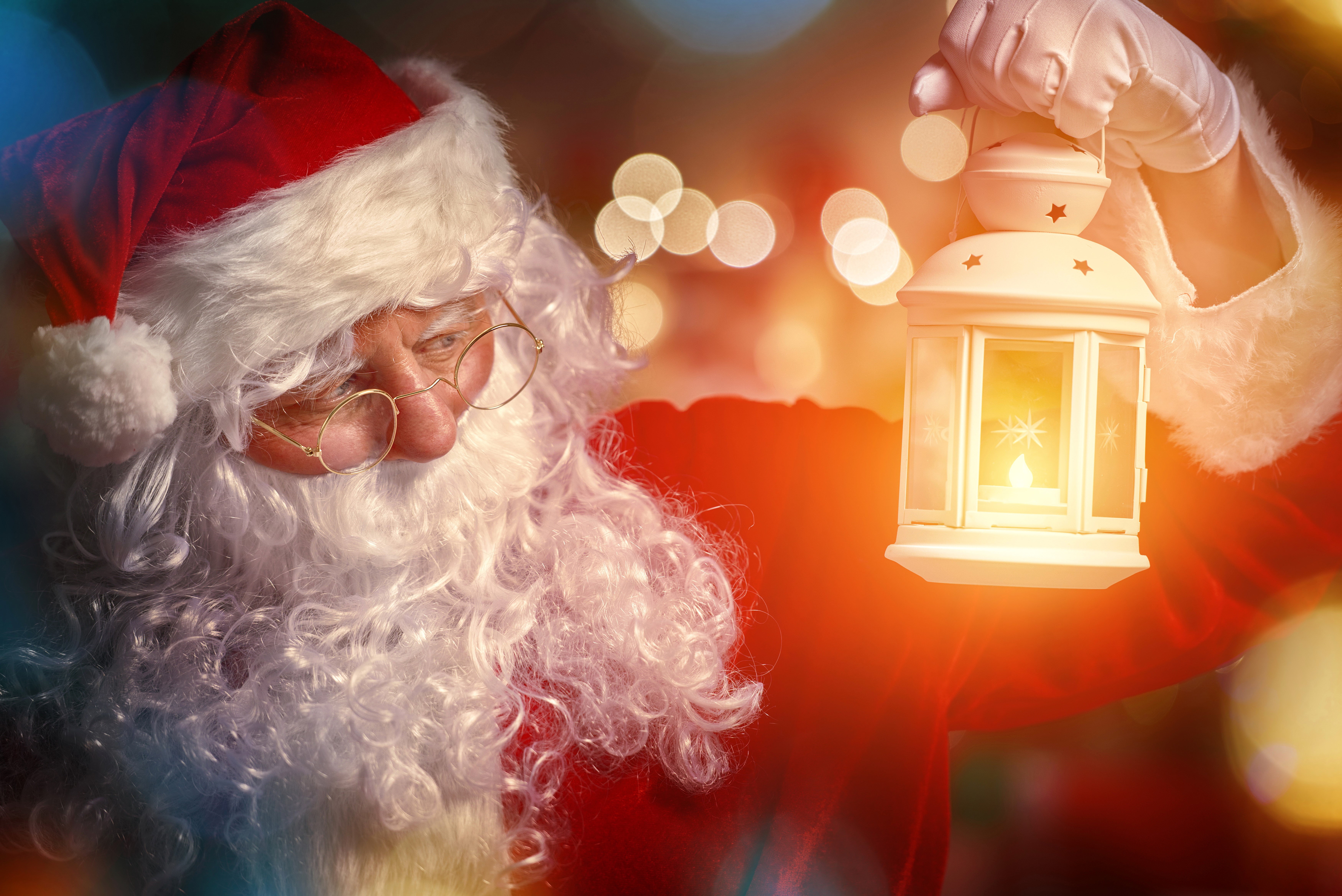 Santa Claus holding a lantern HD Wallpaper