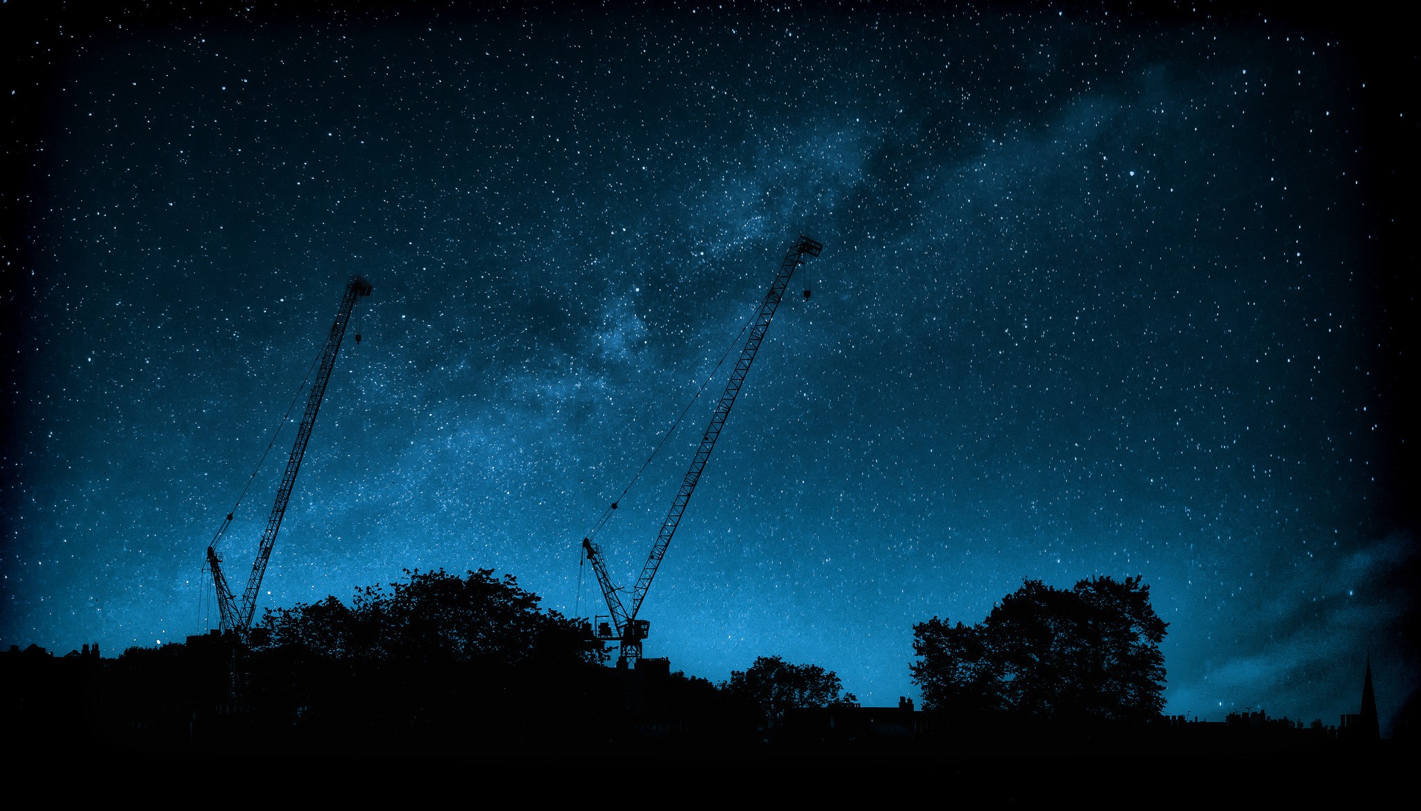 Construction cranes silhouetted against the Milky Way HD Wallpaper